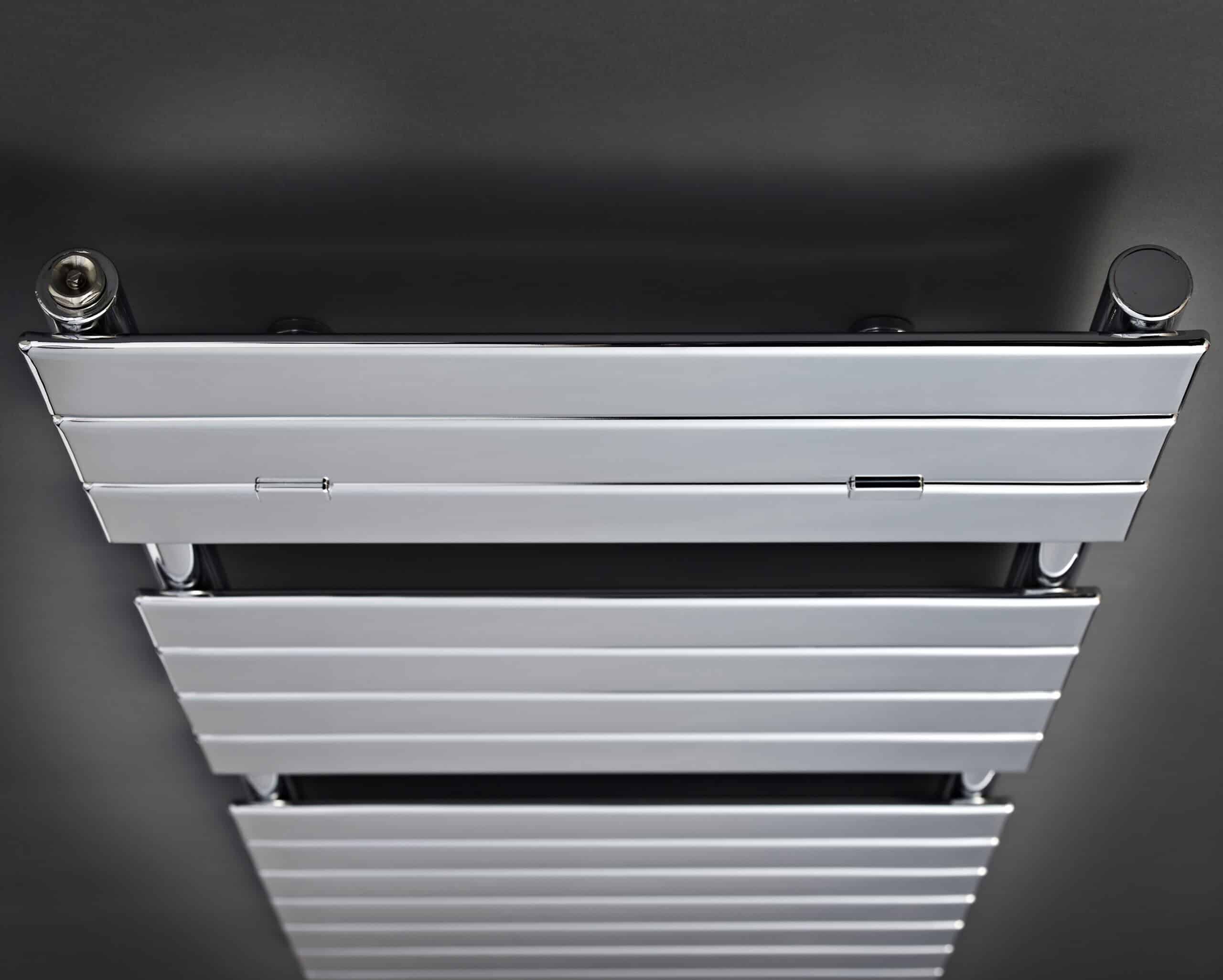 आधुनिक chrome and white heated towel radiator in a contemporary bathroom setting.