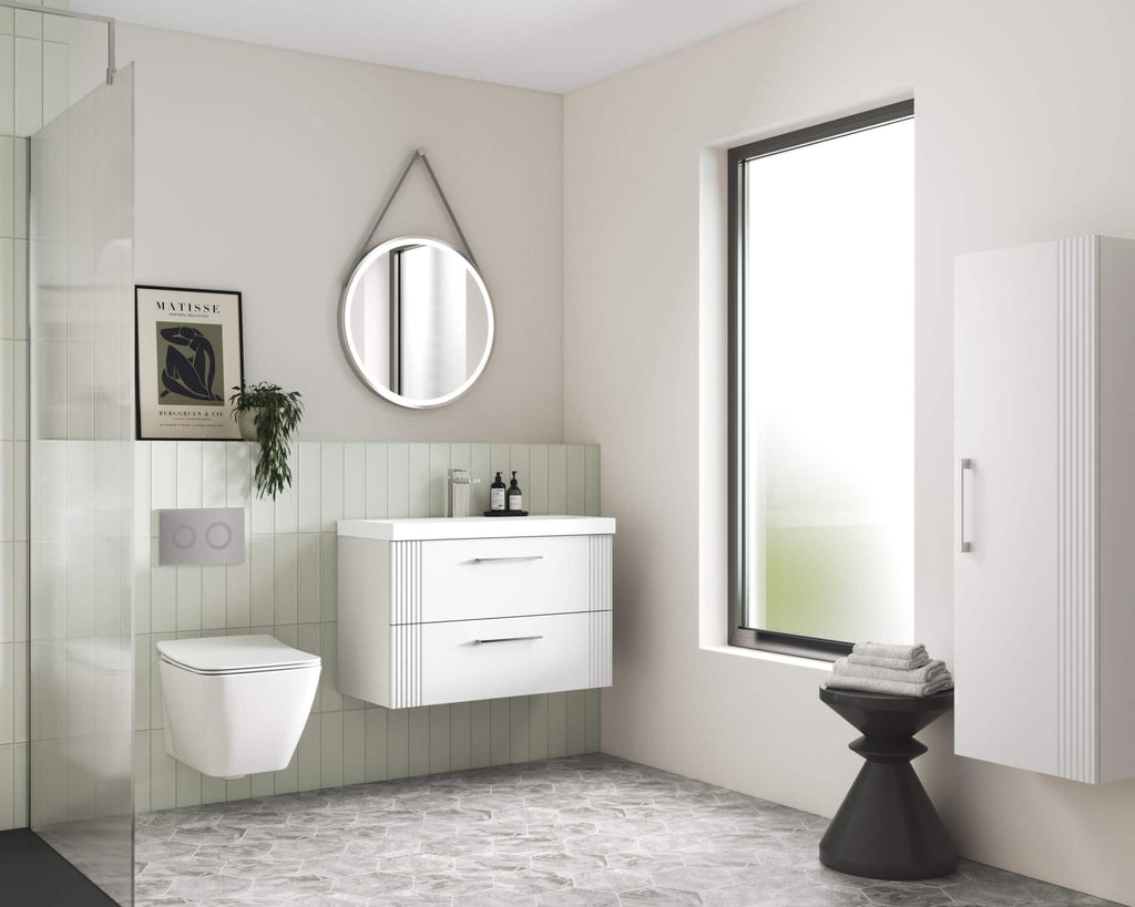 Modern minimalistic bathroom with white vanity unit, wall-mounted toilet, round illuminated mirror, frosted glass window, and stylish accessories; perfect for contemporary bathroom design.