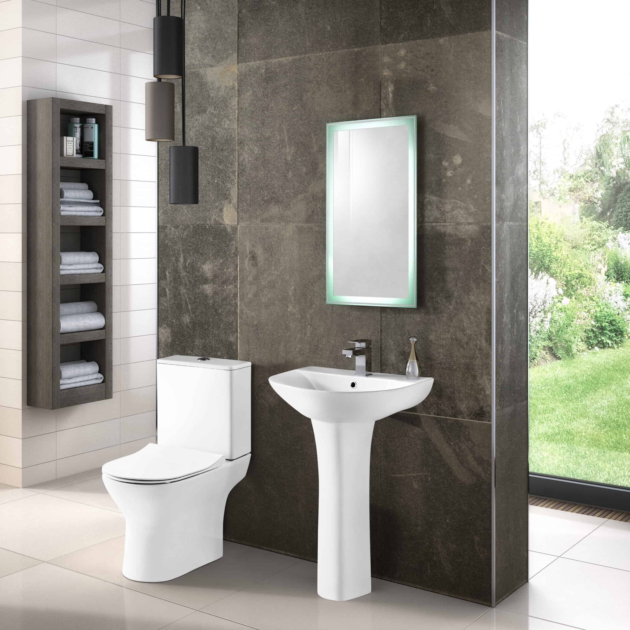 Modern bathroom with white toilet, pedestal sink, illuminated mirror, and decorative storage for towels, featuring a sleek dark wall and large window with garden view.
