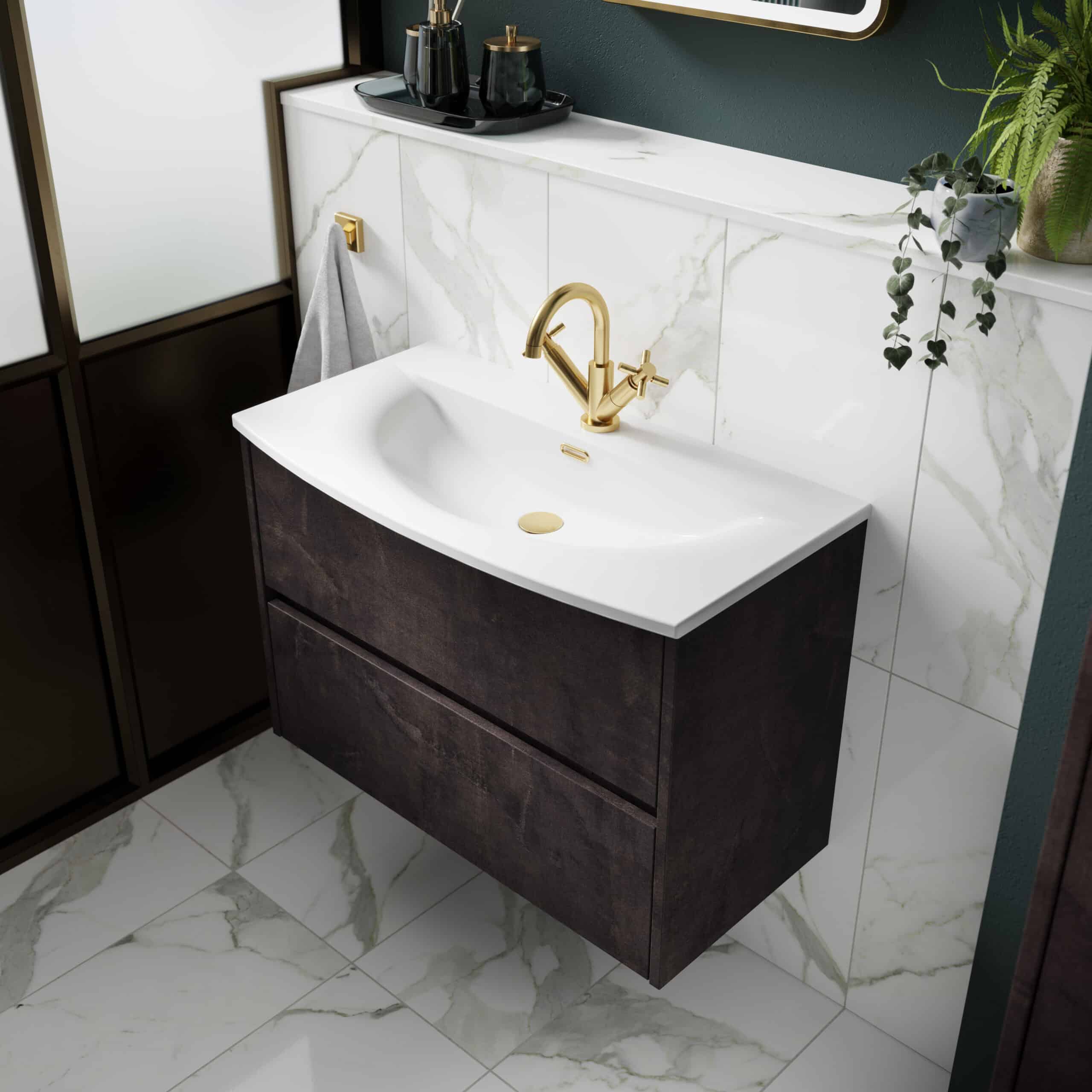 Polished brass bathroom mixer tap and elegant white ceramic sink with dark wood vanity in a modern bathroom setting.