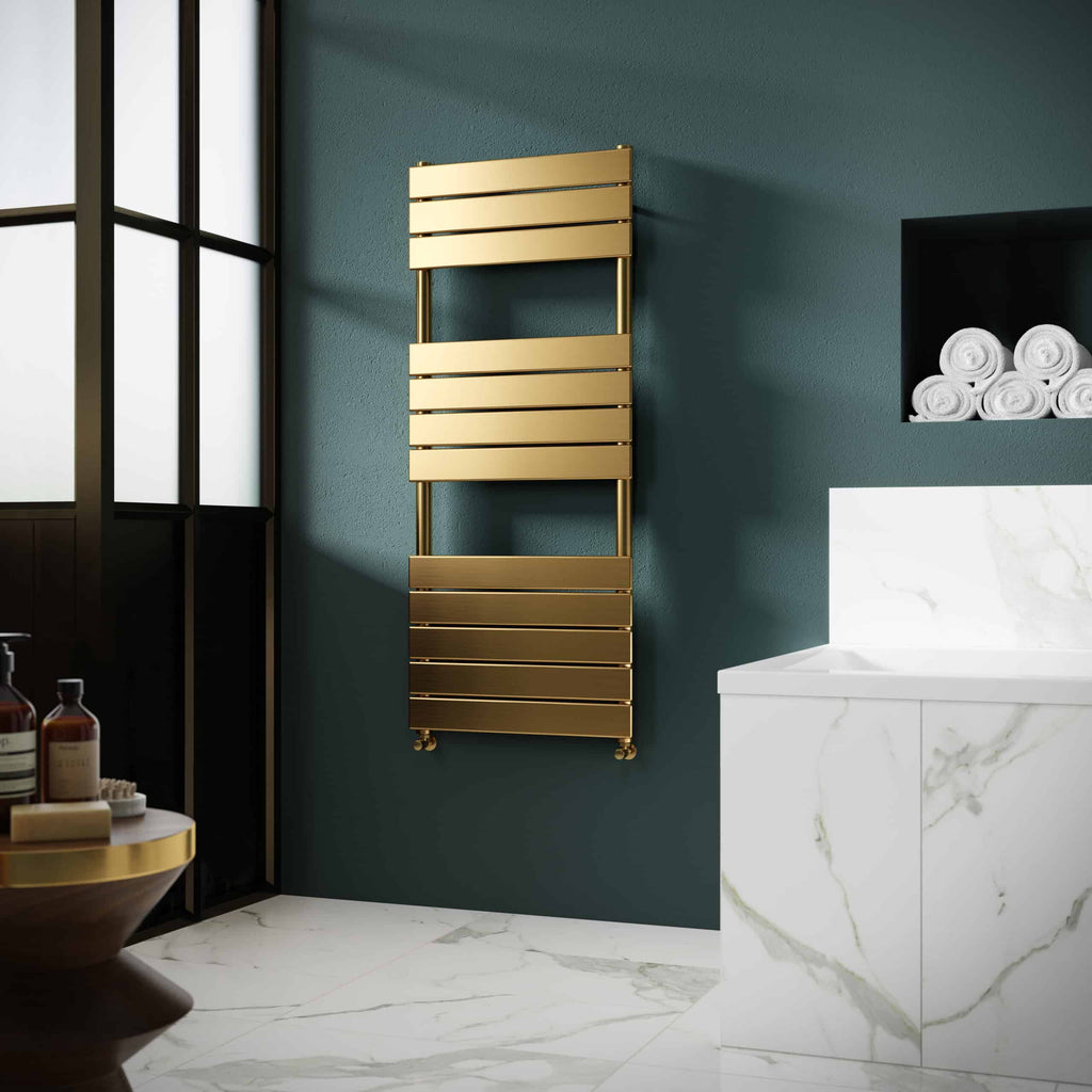 Sleek gold towel radiator mounted on a dark teal bathroom wall with marble flooring and a marble vanity unit, creating a luxurious and modern bathroom design.