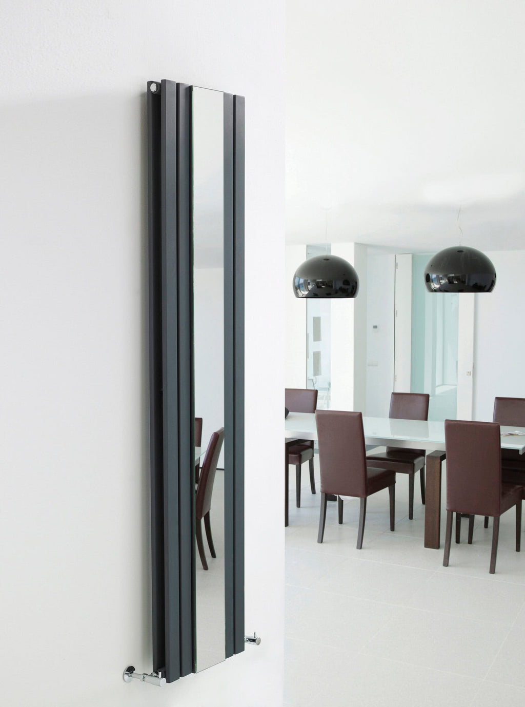 Sleek black vertical radiator in modern bathroom or kitchen, stylish heating solution with minimalist design.