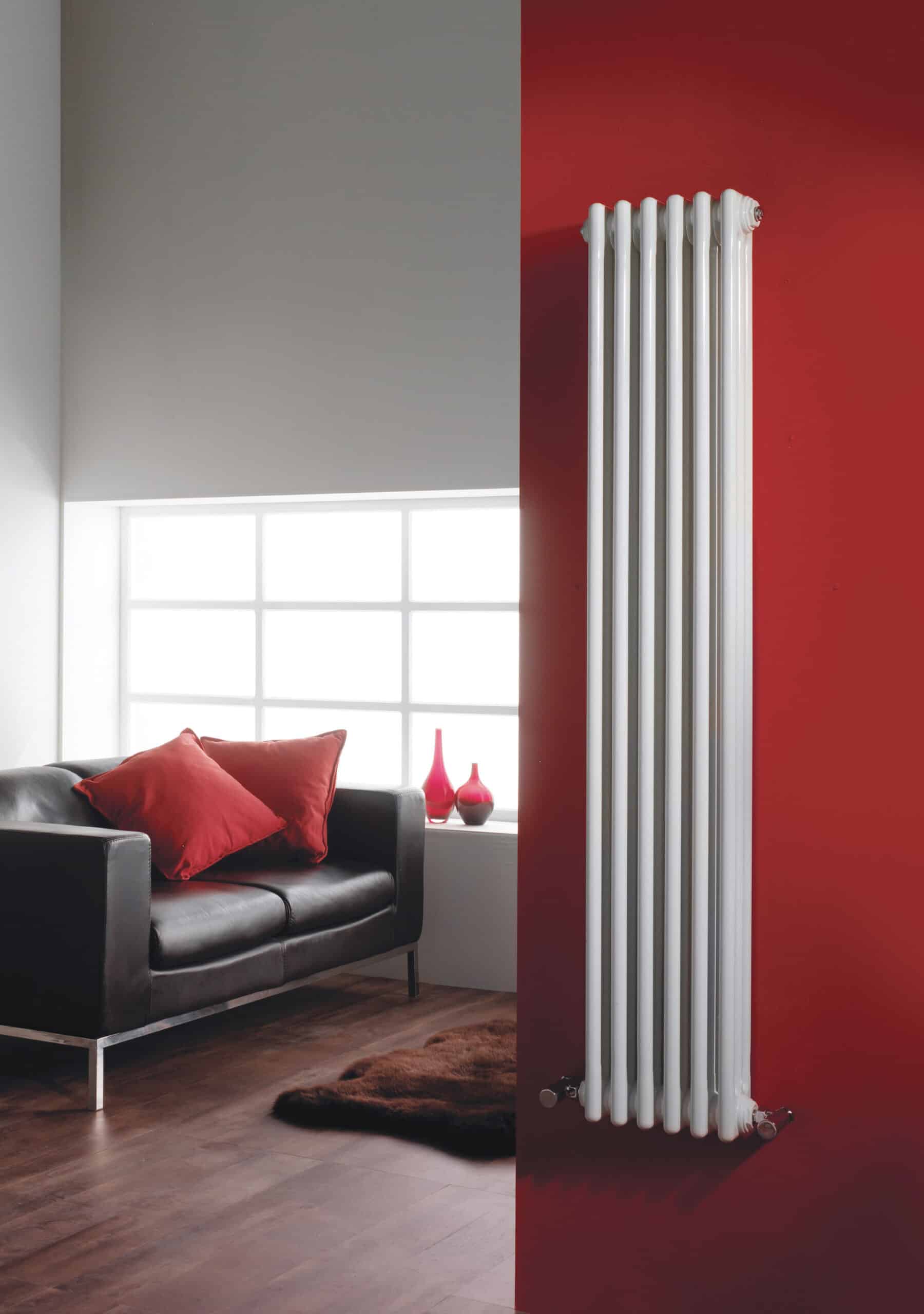 Radiator heating panel in modern bathroom with black sofa and red cushions, stylish radiators, home interior heating, contemporary radiators for bathrooms, Bubly Bathrooms UK.
