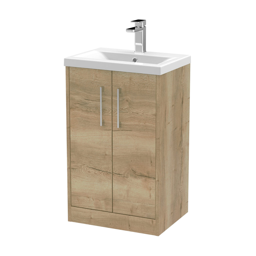 Compact bathroom vanity with wooden cabinet and integrated sink, ideal for modern bathrooms; features chrome handles and a sleek basin with a contemporary tap.