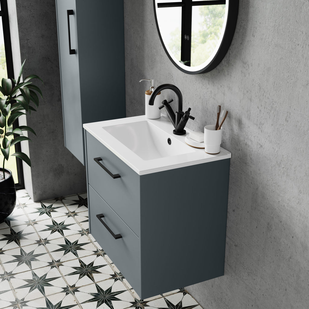 Sleek modern bathroom vanity with a blue-grey cabinet, white sink, black tap, and round mirror, showcasing contemporary bathroom design.