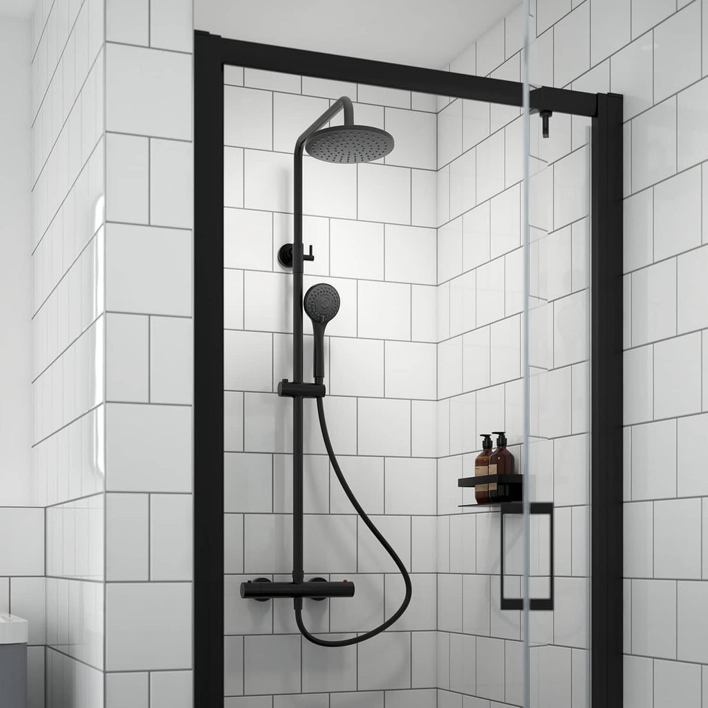 Modern black rainfall shower with handheld attachment in a stylish white-tiled bathroom shower enclosure.