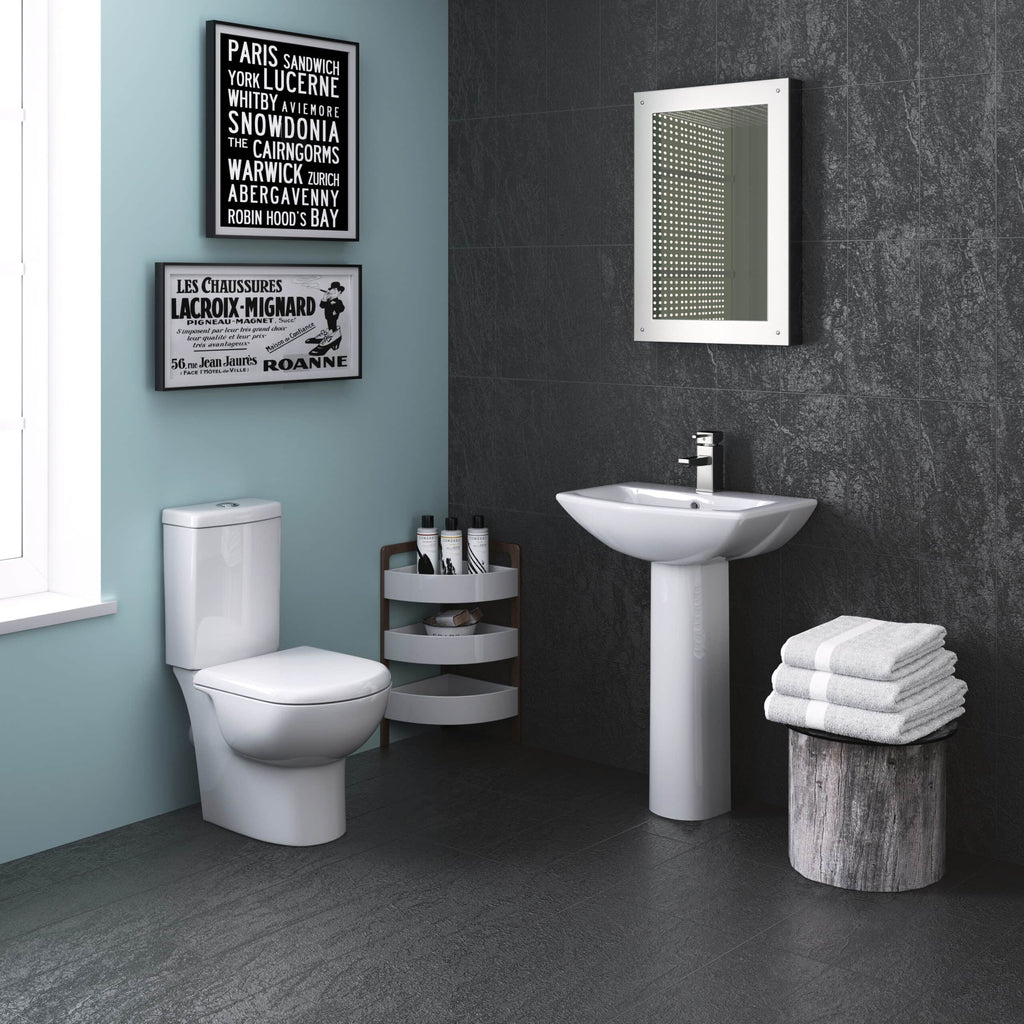 Modern bathroom with white toilet, pedestal sink, black textured wall tiles, and stylish decor, perfect for contemporary bathroom renovations and fittings.