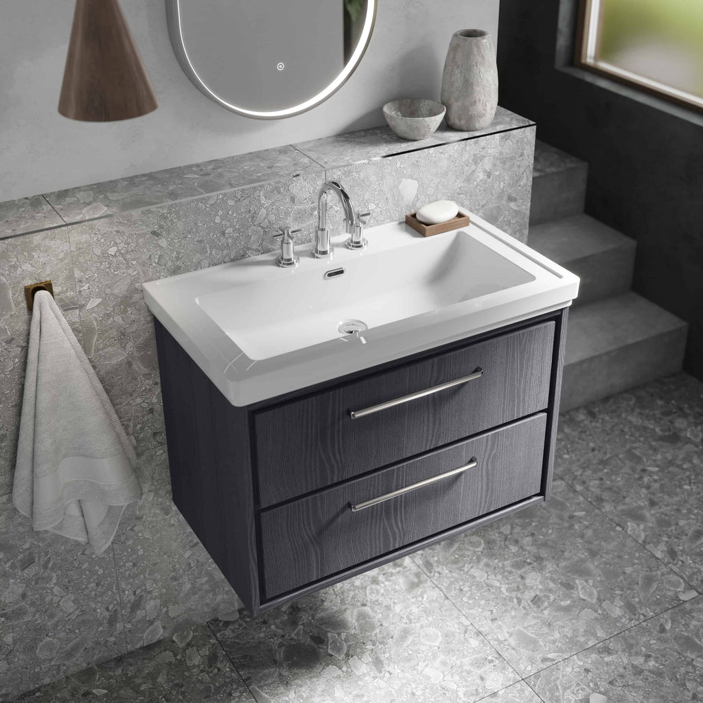Modern bathroom vanity with a sleek white ceramic sink and dark wood cabinet, featuring double drawers with contemporary chrome handles. Perfect for stylish bathroom decor and functional storage.