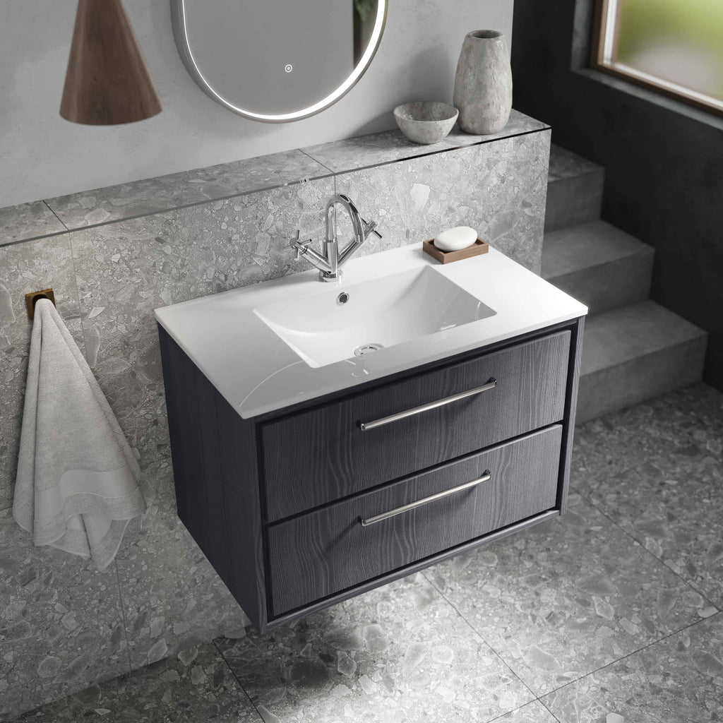 Contemporary bathroom vanity with a sleek black finish, white ceramic sink, modern chrome faucet, and minimalist decor, offering stylish bathroom storage solutions.