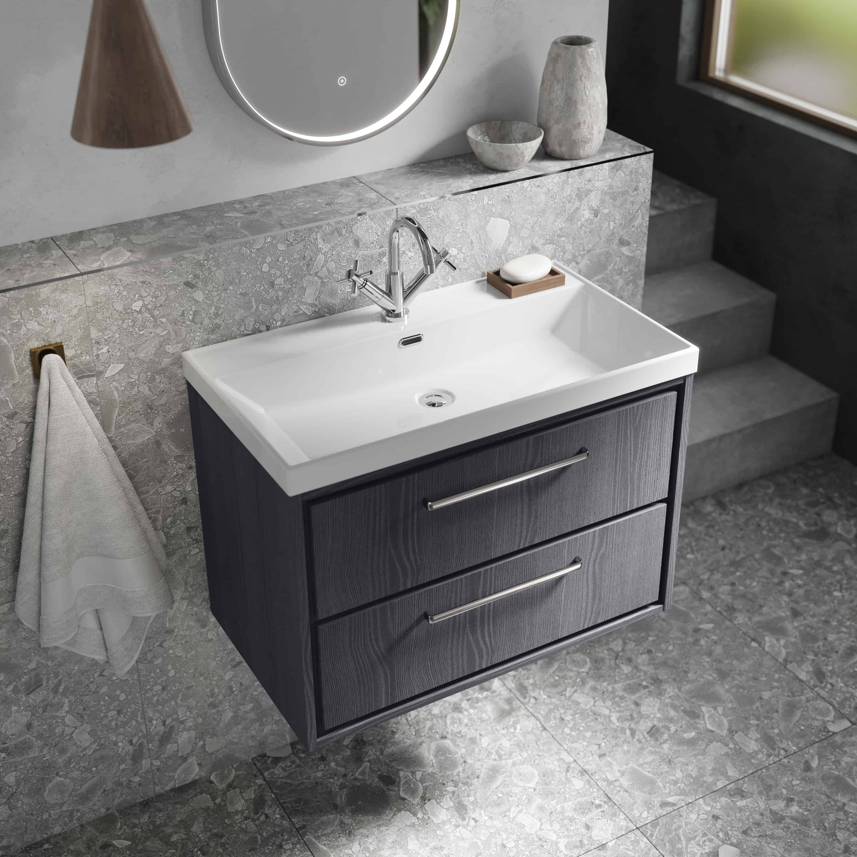 Modern bathroom vanity with a sleek white ceramic sink, dark wood cabinet drawers, and chrome handles in a stylish contemporary bathroom setting.