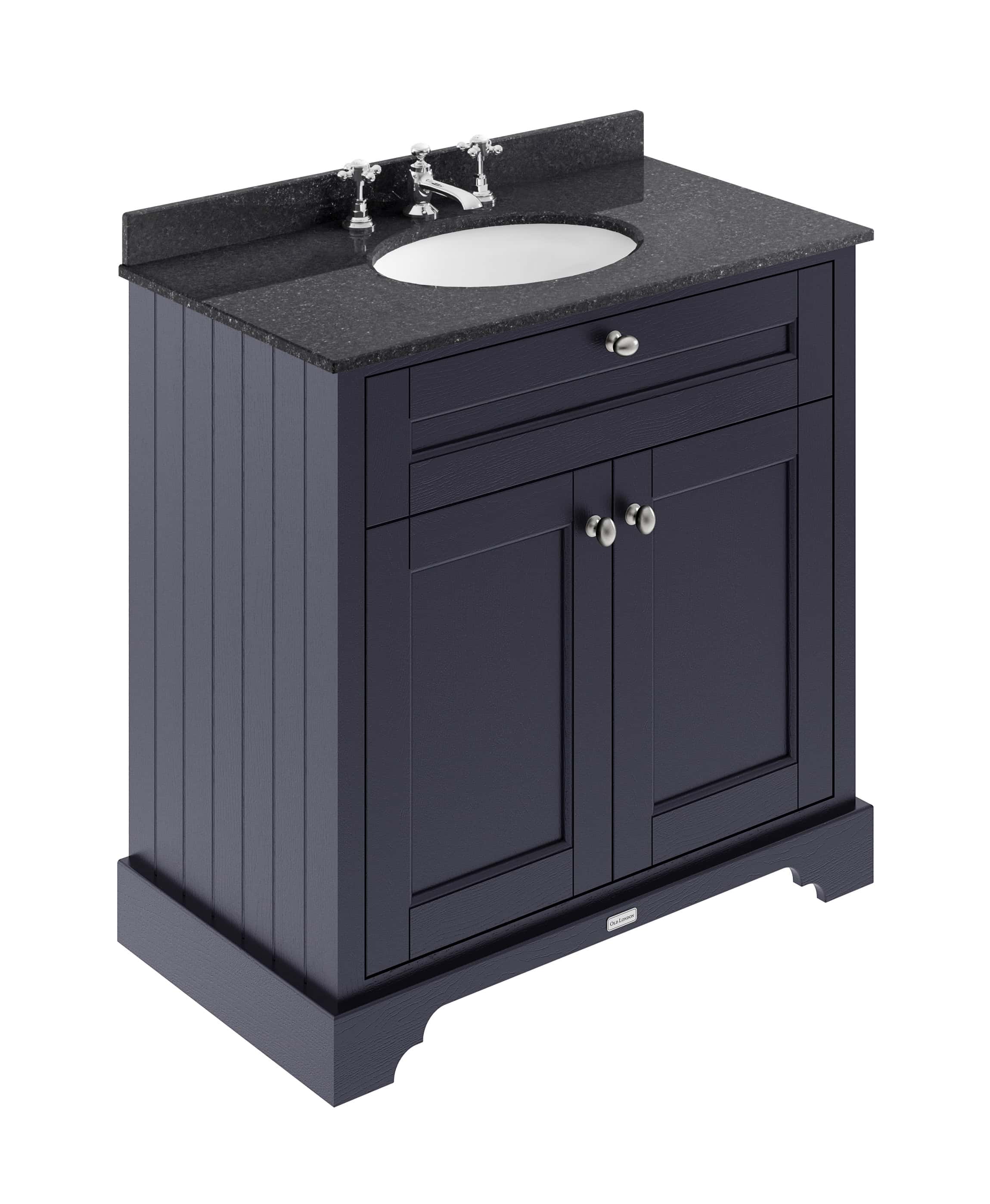 Dark navy bathroom vanity with black granite countertop and built-in sink, featuring traditional beadboard paneling and silver hardware for a classic, elegant bathroom look.