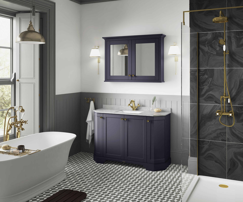 Luxurious bathroom with a white freestanding bathtub, navy blue vanity with marble countertop, and elegant black and gold shower wall, combining classic and modern design elements.
