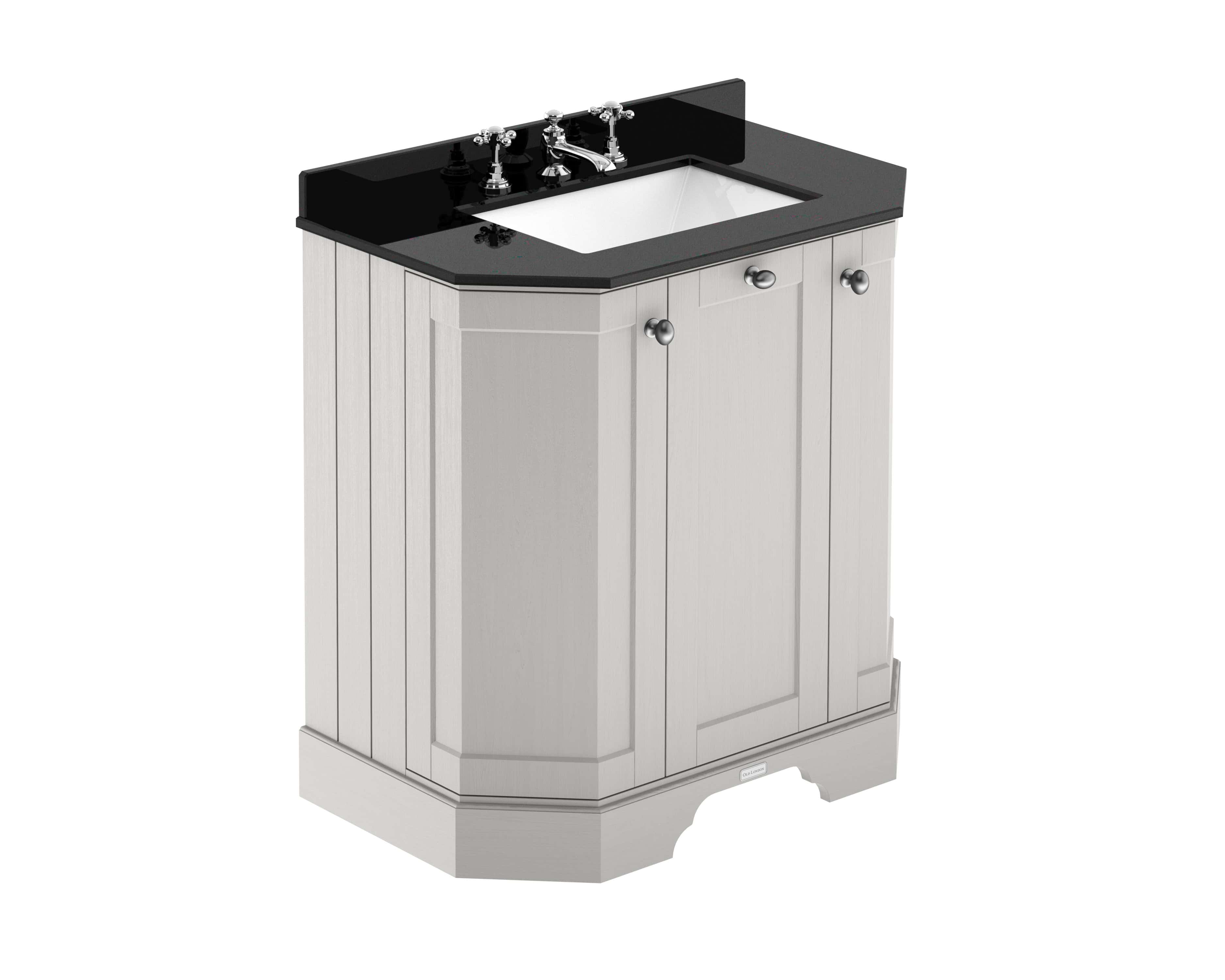 Polished bathroom vanity with black countertop and white inset sink, traditional style with cabinet storage, chrome fixtures, suitable for classic bathroom design.