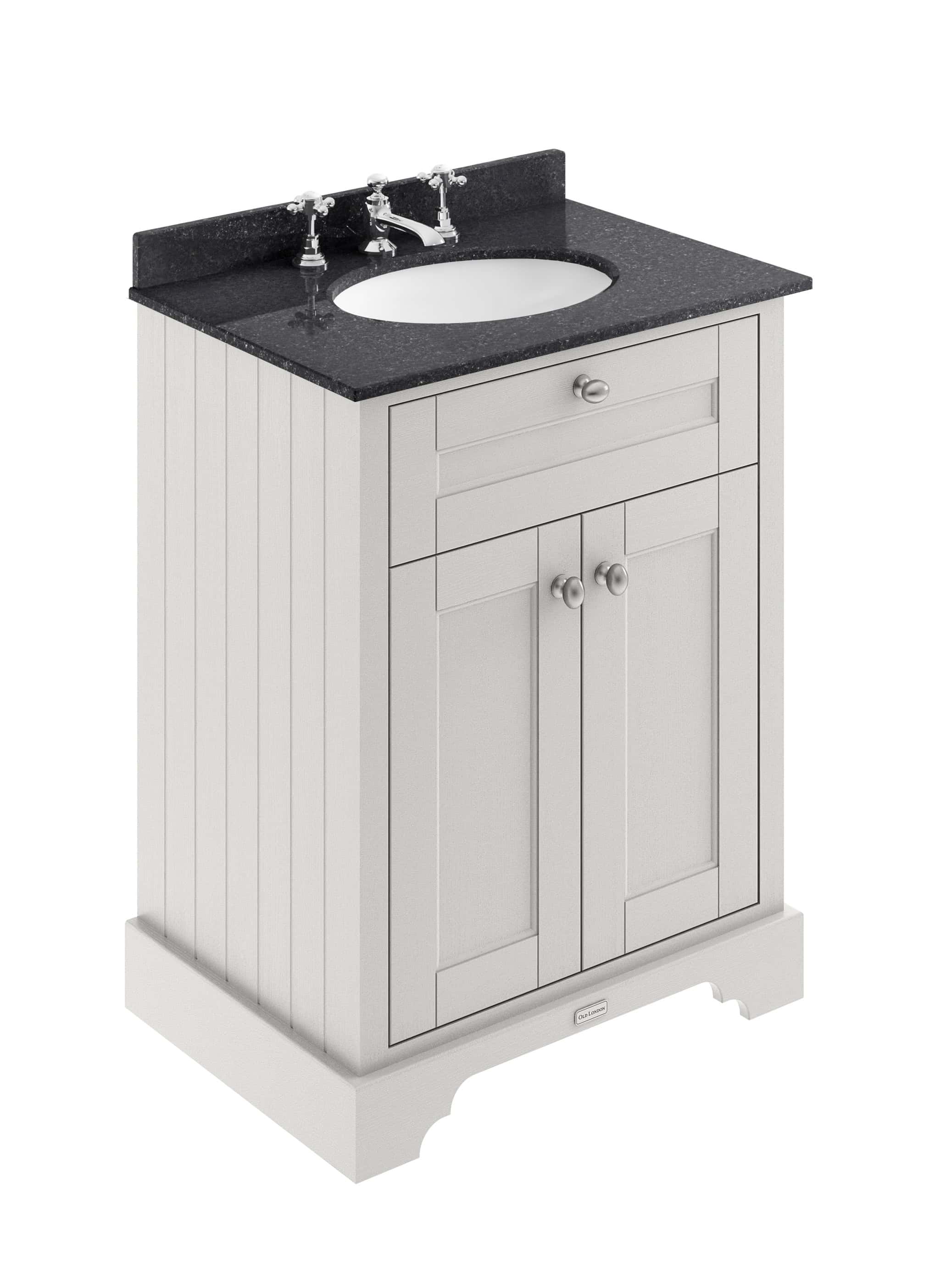 Polished bathroom vanity unit with black granite countertop and white wooden cabinet for elegant bathroom storage and countertop sink setup.