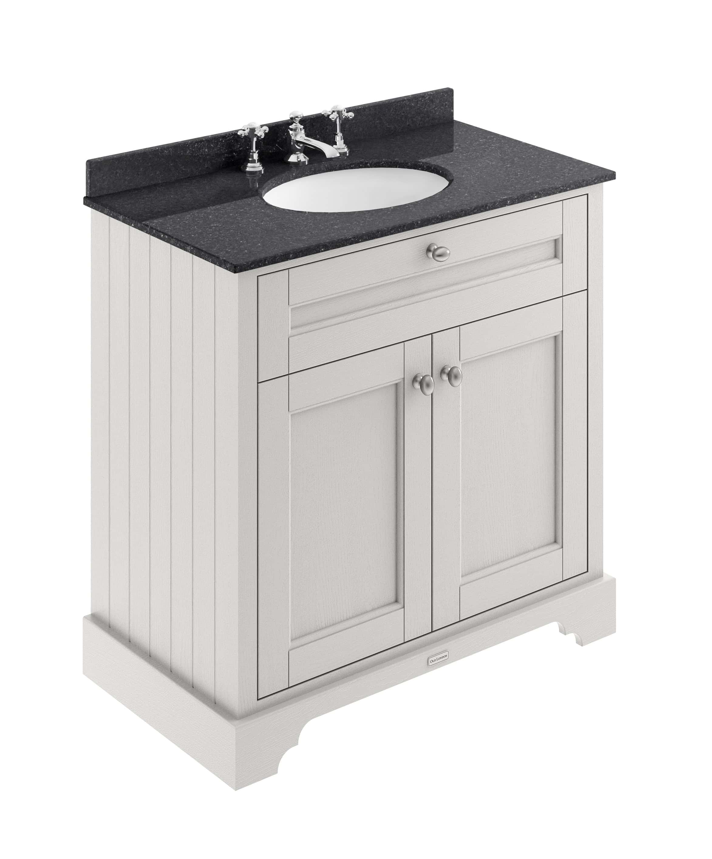 Polished white bathroom vanity with black granite countertop and porcelain sink, traditional cabinet design, ideal for classic bathroom decor.