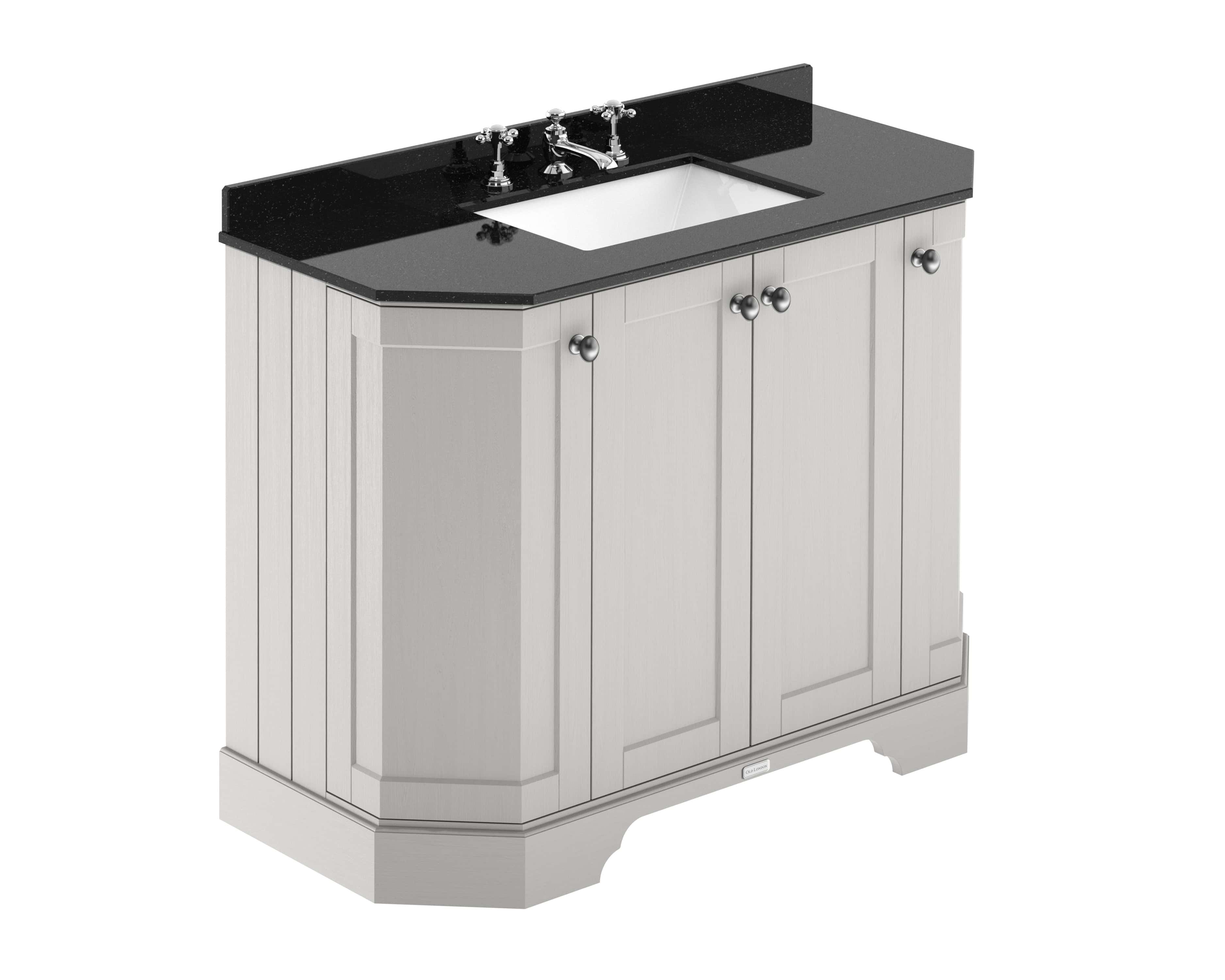 Polished black granite bathroom vanity unit with white ceramic sink and traditional tap fittings.