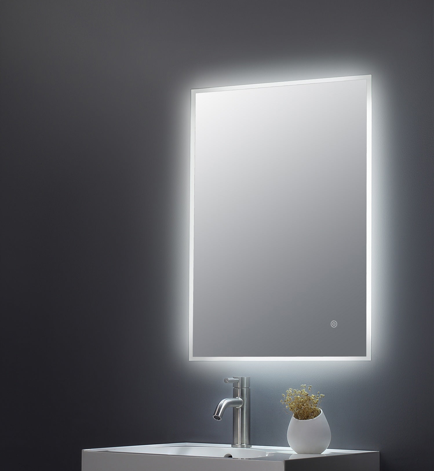 Illuminated LED bathroom mirror above a sleek white sink with a modern chrome faucet, featuring ambient lighting perfect for modern bathroom decor and grooming routines.