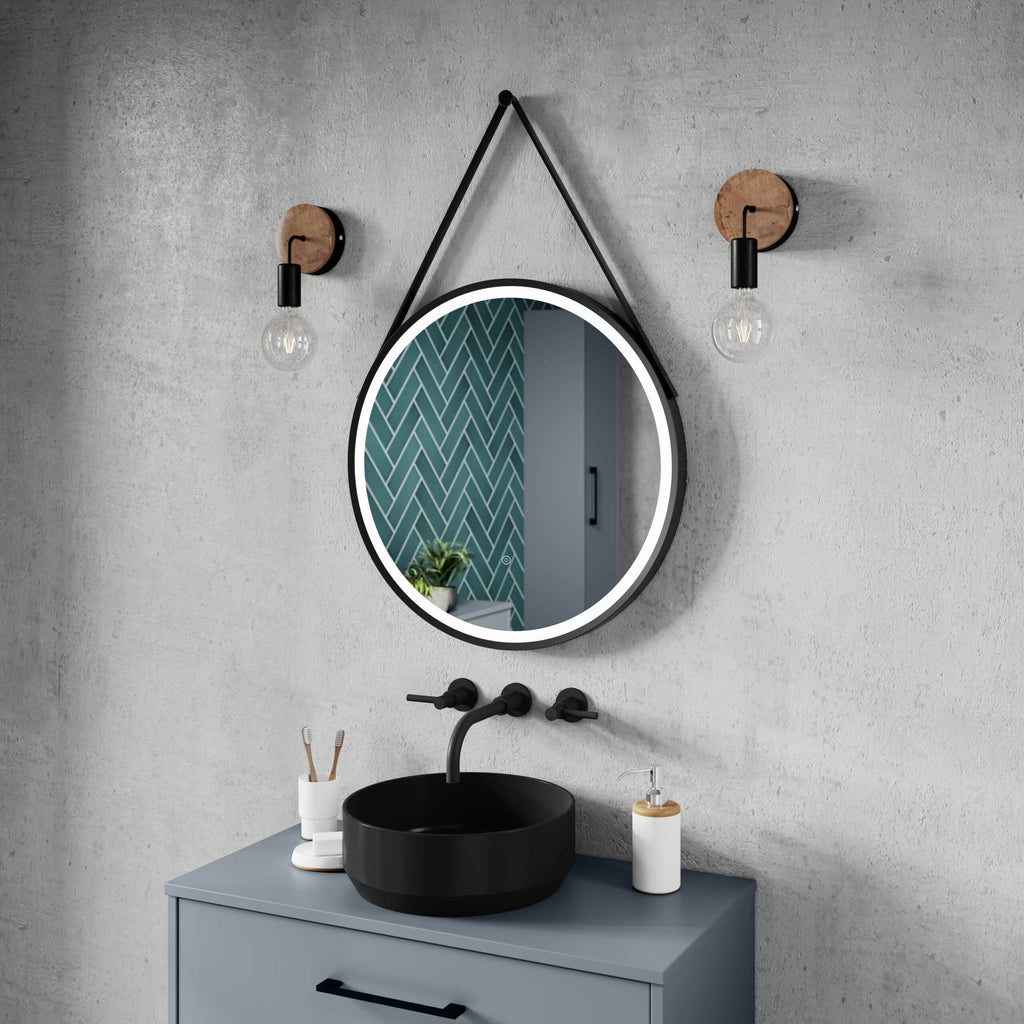 Round illuminated bathroom mirror with black bathroom sink and modern fixtures on grey wall, with stylish lighting and decor, perfect for contemporary bathroom design.