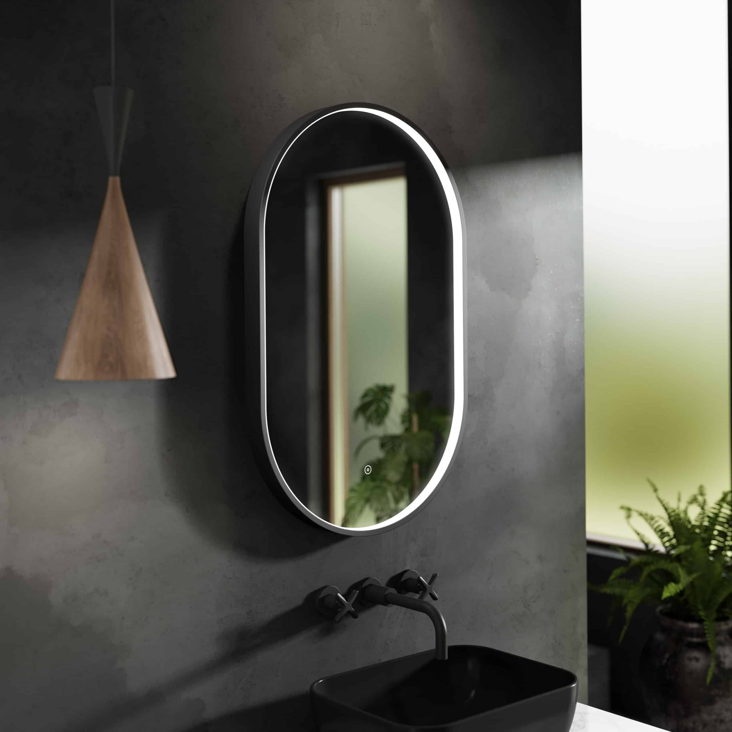 Contemporary oval mirror with LED lighting in a modern bathroom setting, complementing minimalist design and sleek black fixtures.