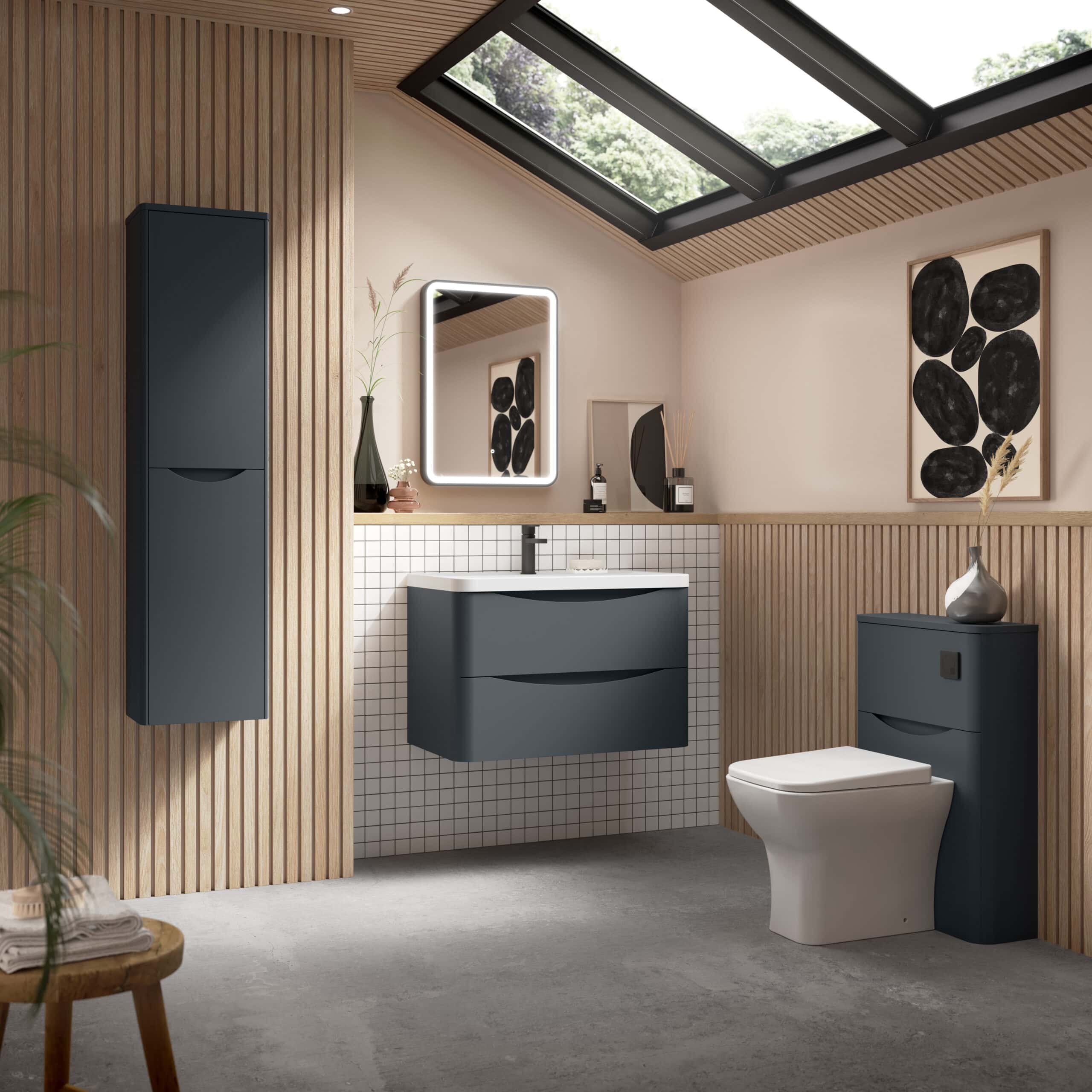 Sleek modern bathroom with dark navy vanity units, a wall-mounted cabinet, white tiled splashback, artwork, and natural light from skylights, creating a contemporary and stylish space.