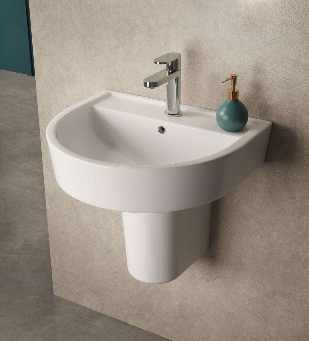 Sleek white wall-mounted bathroom basin with modern chrome tap and teal soap dispenser, ideal for contemporary bathroom decor.