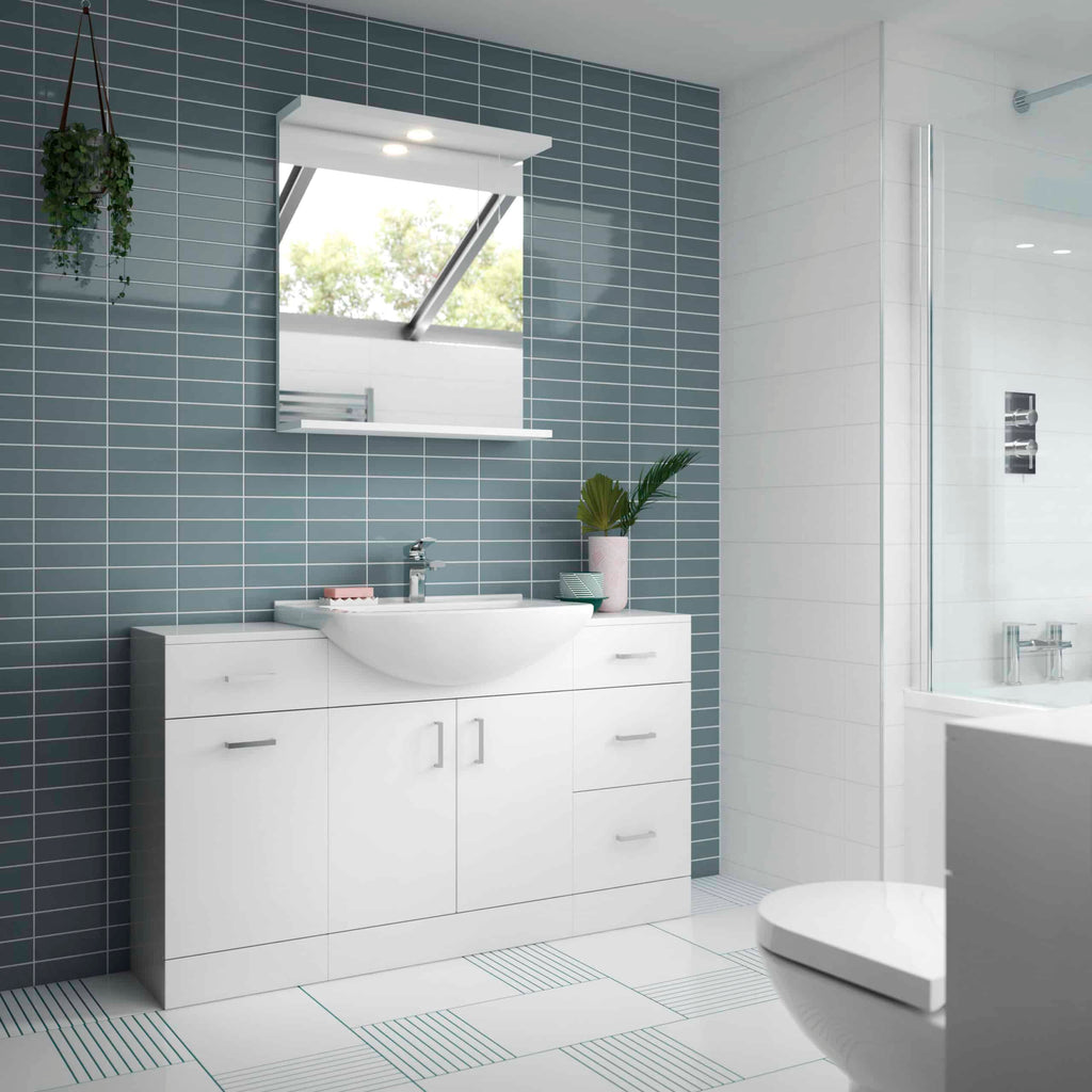Modern white bathroom vanity with sink, blue tiled accent wall, and large mirror in contemporary bathroom setup.