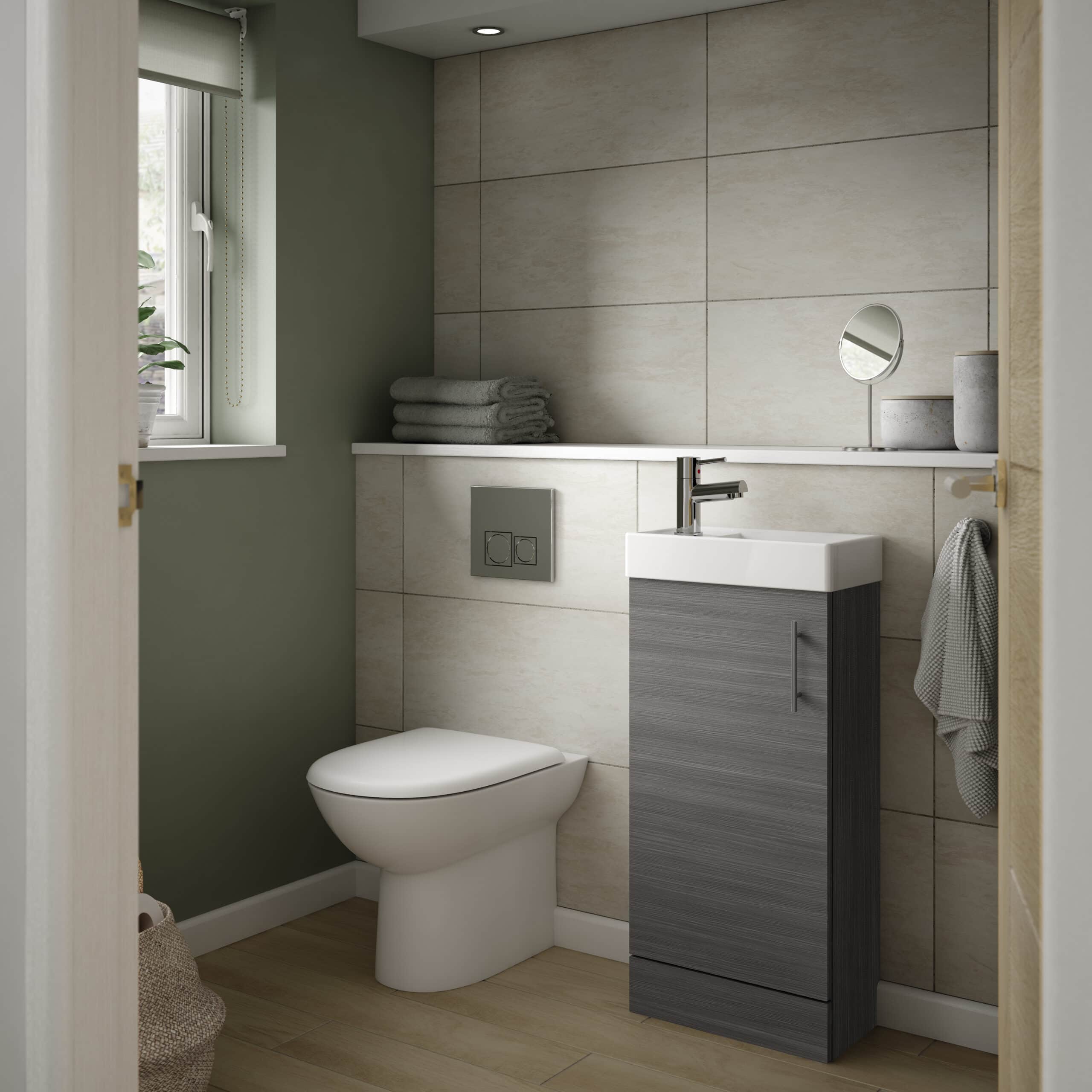 Modern compact bathroom with smart wall-mounted toilet, small grey vanity unit, and minimalist decor, perfect for space-saving bathroom designs and renovation projects.
