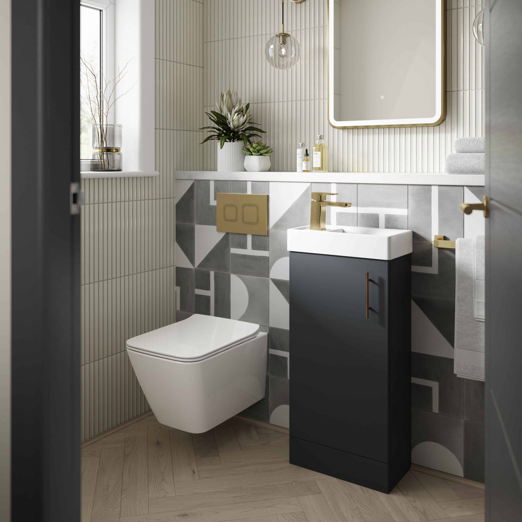Modern bathroom with sleek black vanity, geometric tile accents, wall-mounted toilet, stylish mirror, and contemporary decor, creating an elegant and functional space.