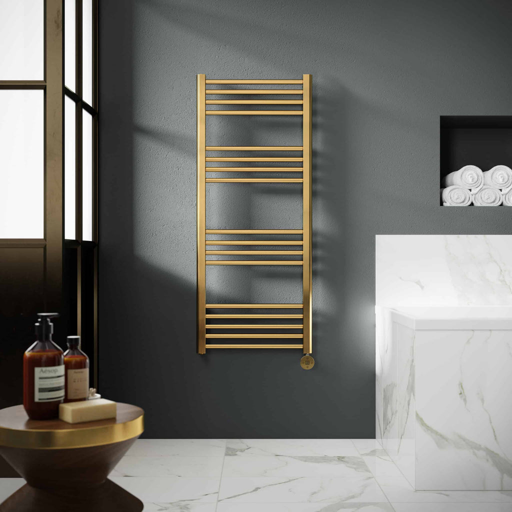 Luxurious gold towel radiator heating system in modern bathroom decor with marble surfaces and minimalist design.