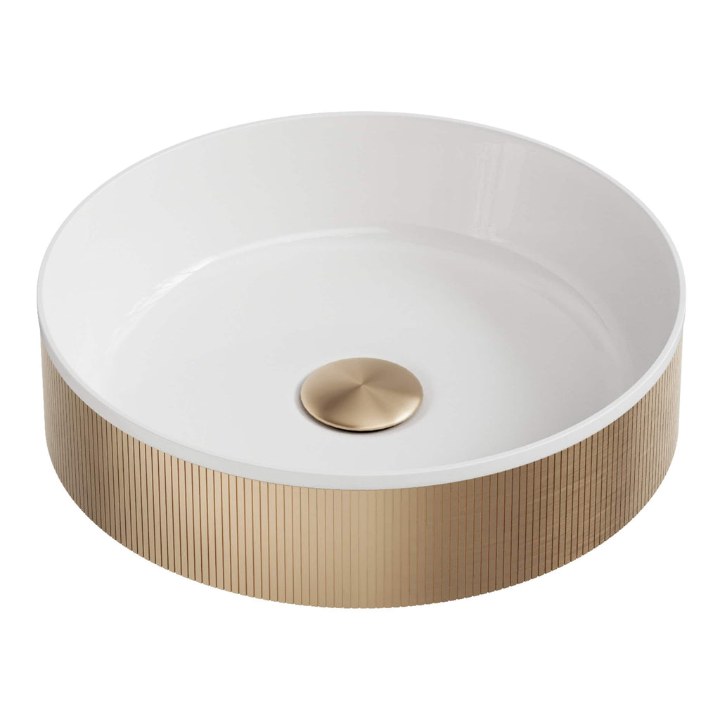 Luxurious round bathroom sink with a white interior basin and a textured gold exterior, featuring a sleek brass drain for a modern bathroom aesthetic.