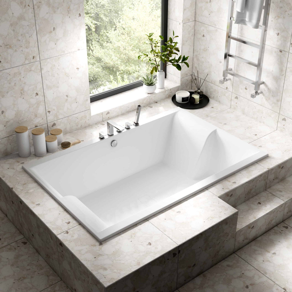 Modern freestanding bathtub in a contemporary bathroom with beige marble tiles, large window, lush green outdoor view, and sleek chrome fixtures for a luxurious bathroom remodel.