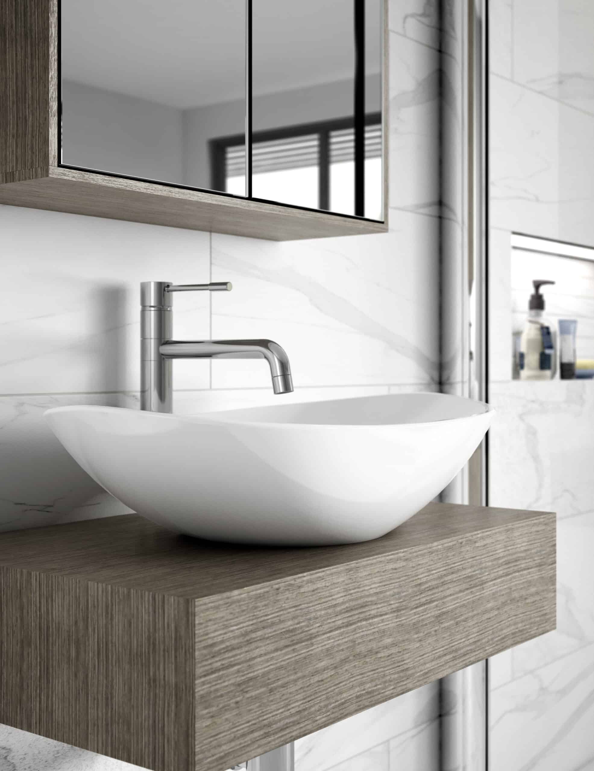 Sleek modern bathroom sink with a contemporary brushed nickel faucet, mounted on a wooden vanity with a minimalist design in a luxurious bathroom with white marble walls and a mirror.