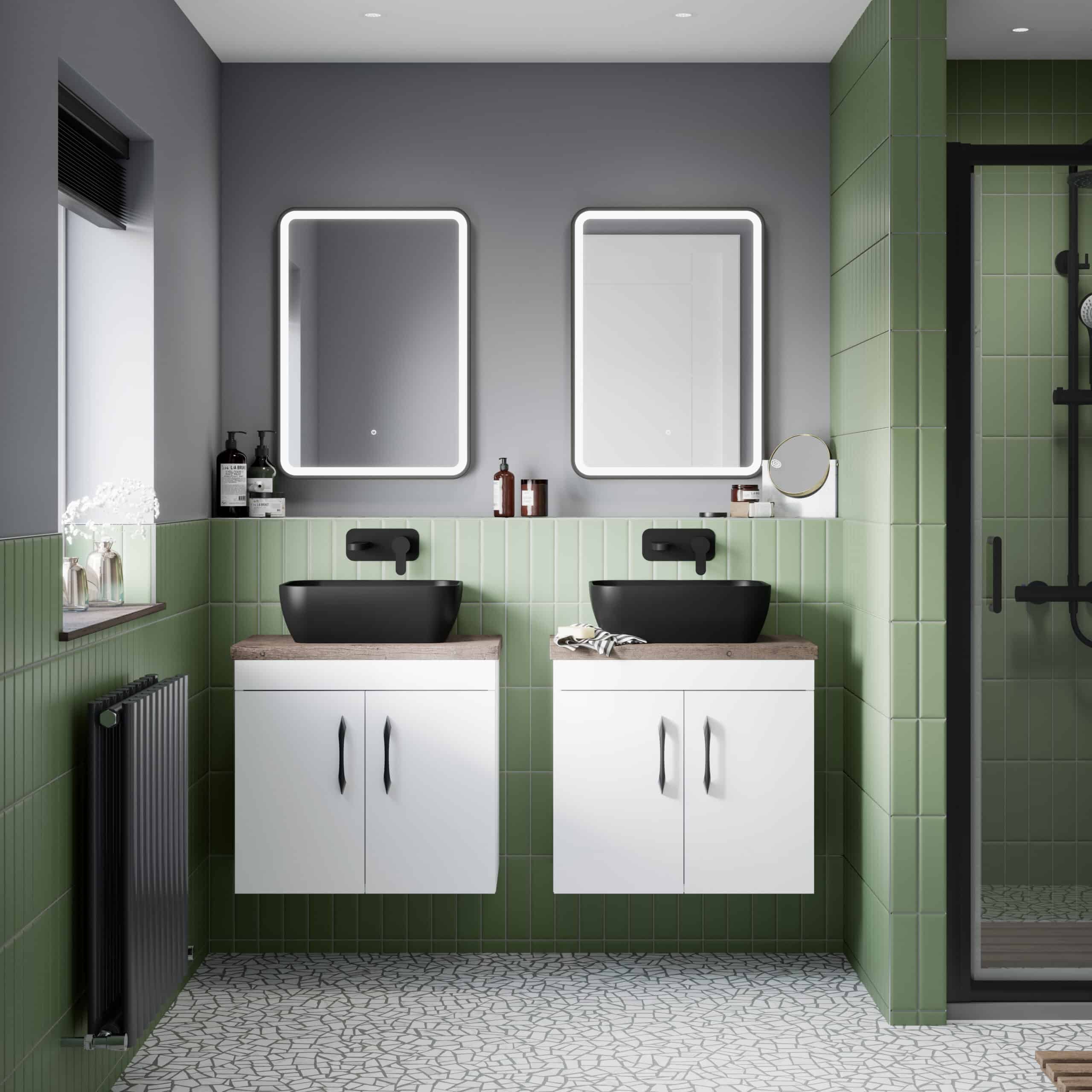 Modern bathroom with double washbasins, black sinks, illuminated mirrors, green tiled walls, and contemporary decor, featuring a shower enclosure for stylish bathroom design.