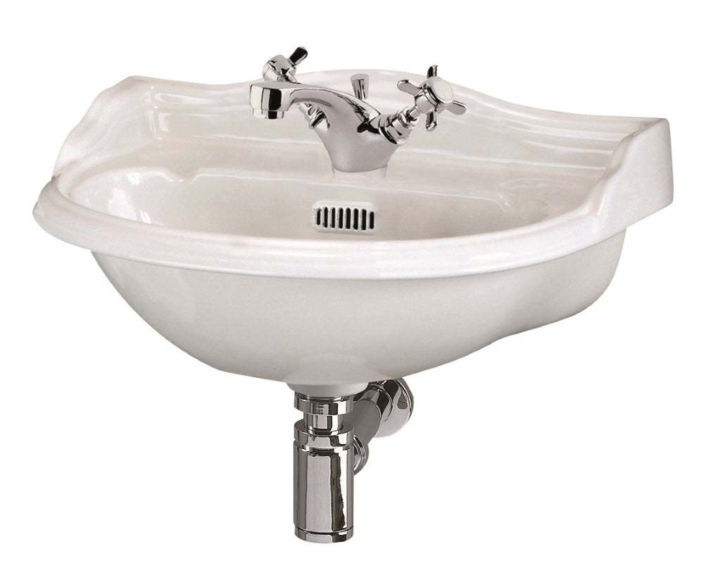Vintage ceramic corner sink with chrome taps, ideal for bathroom or kitchen installations. Features a stylish design and durable construction, perfect for modern or traditional bathroom styles.