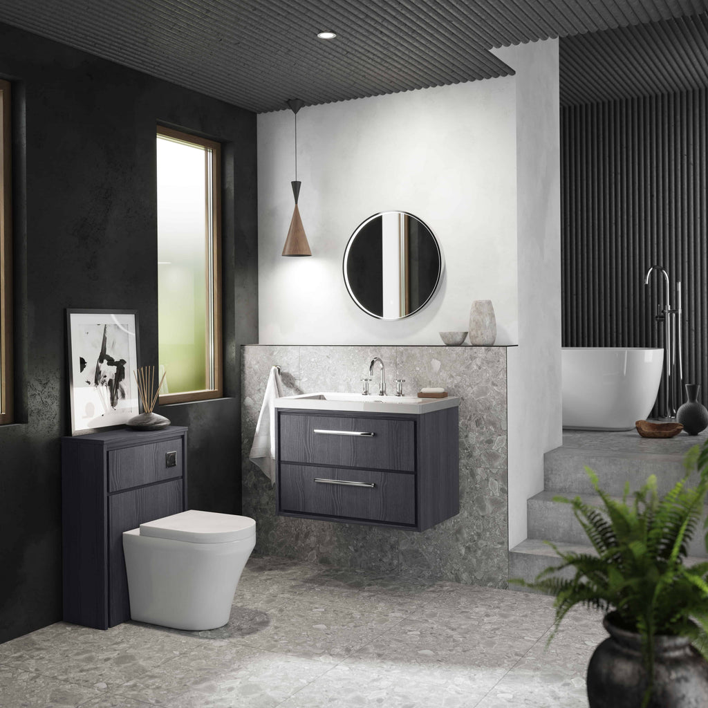 Contemporary bathroom featuring a modern wall-mounted vanity unit with a white countertop and sleek mirror, complemented by a stylish toilet and freestanding bathtub in a chic, minimalistic design with natural light.