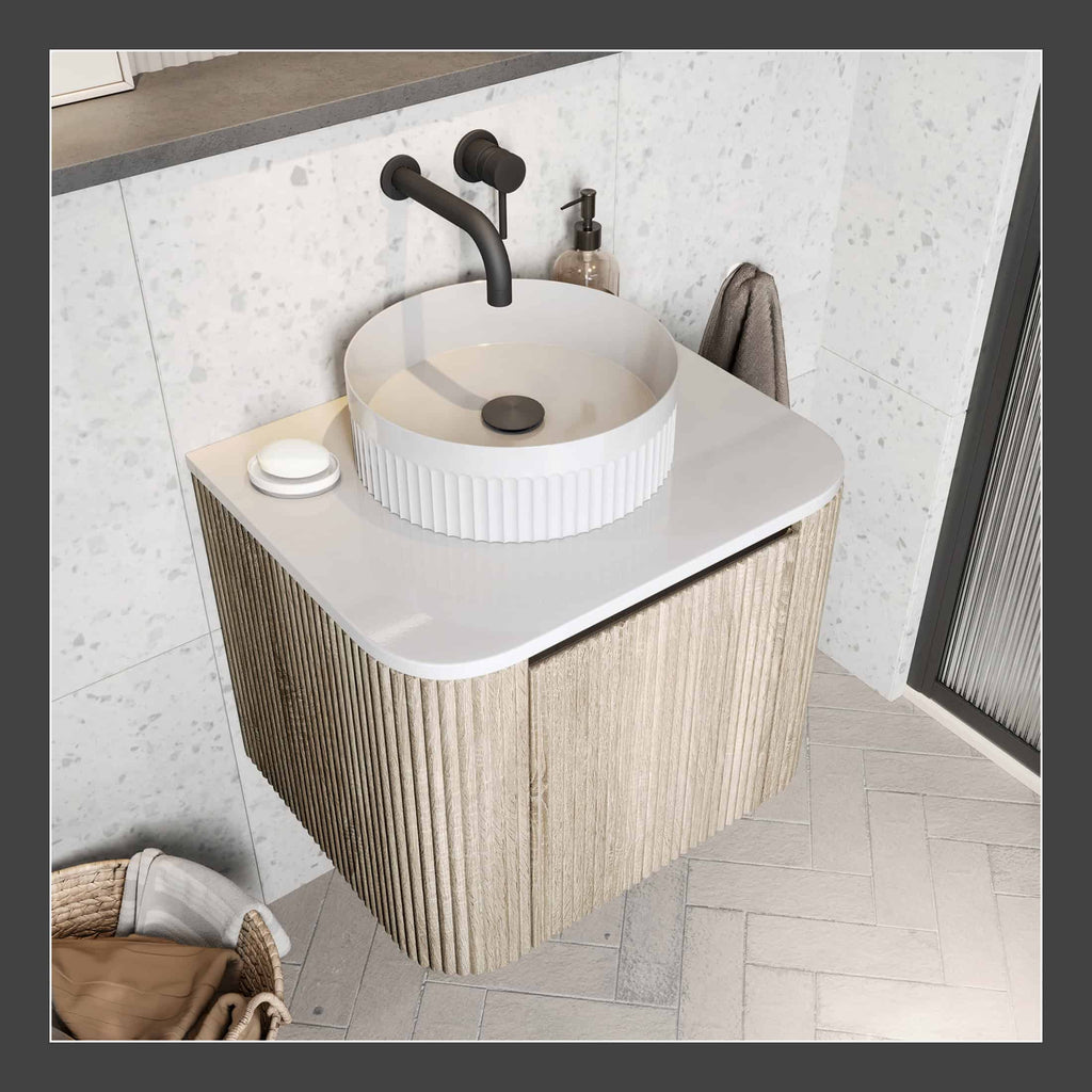 Sleek modern bathroom vanity with a round white vessel sink, black matte tap, and light wood textured cabinet, creating a stylish and functional space.