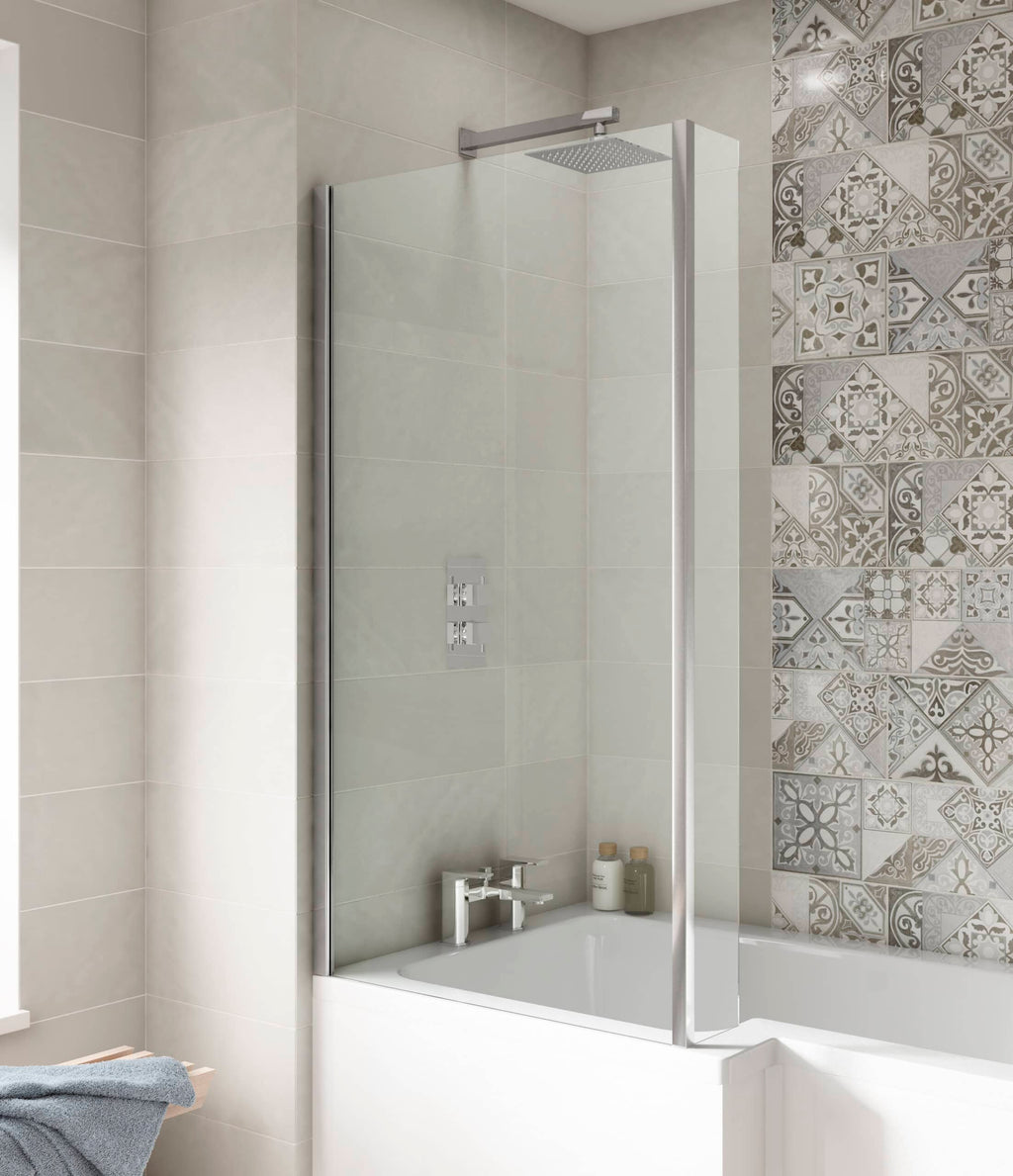 Sleek shower enclosure with glass screen in modern bathroom with beige and patterned wall tiles.