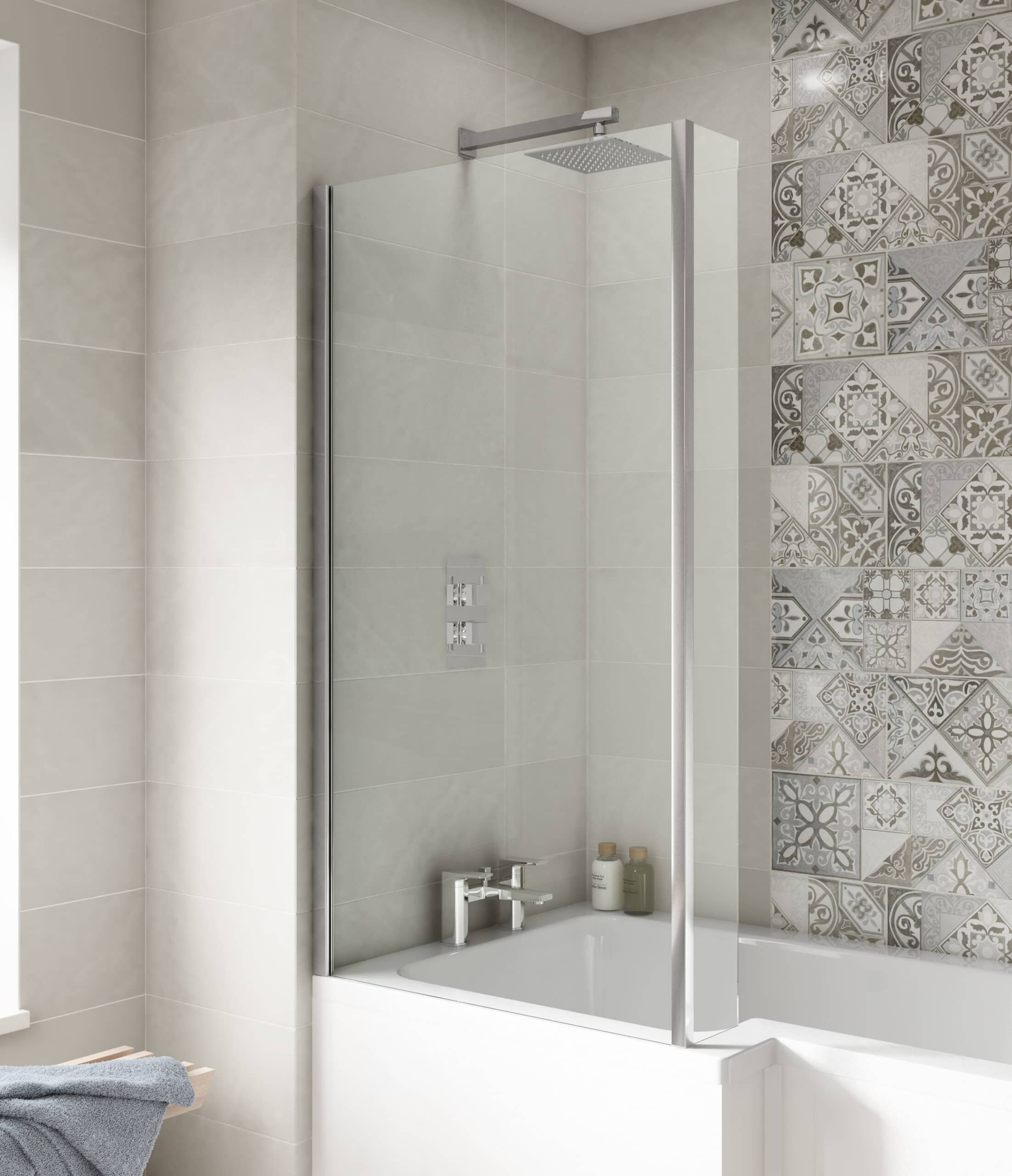 Sleek shower enclosure with glass screen in modern bathroom with beige and patterned wall tiles.