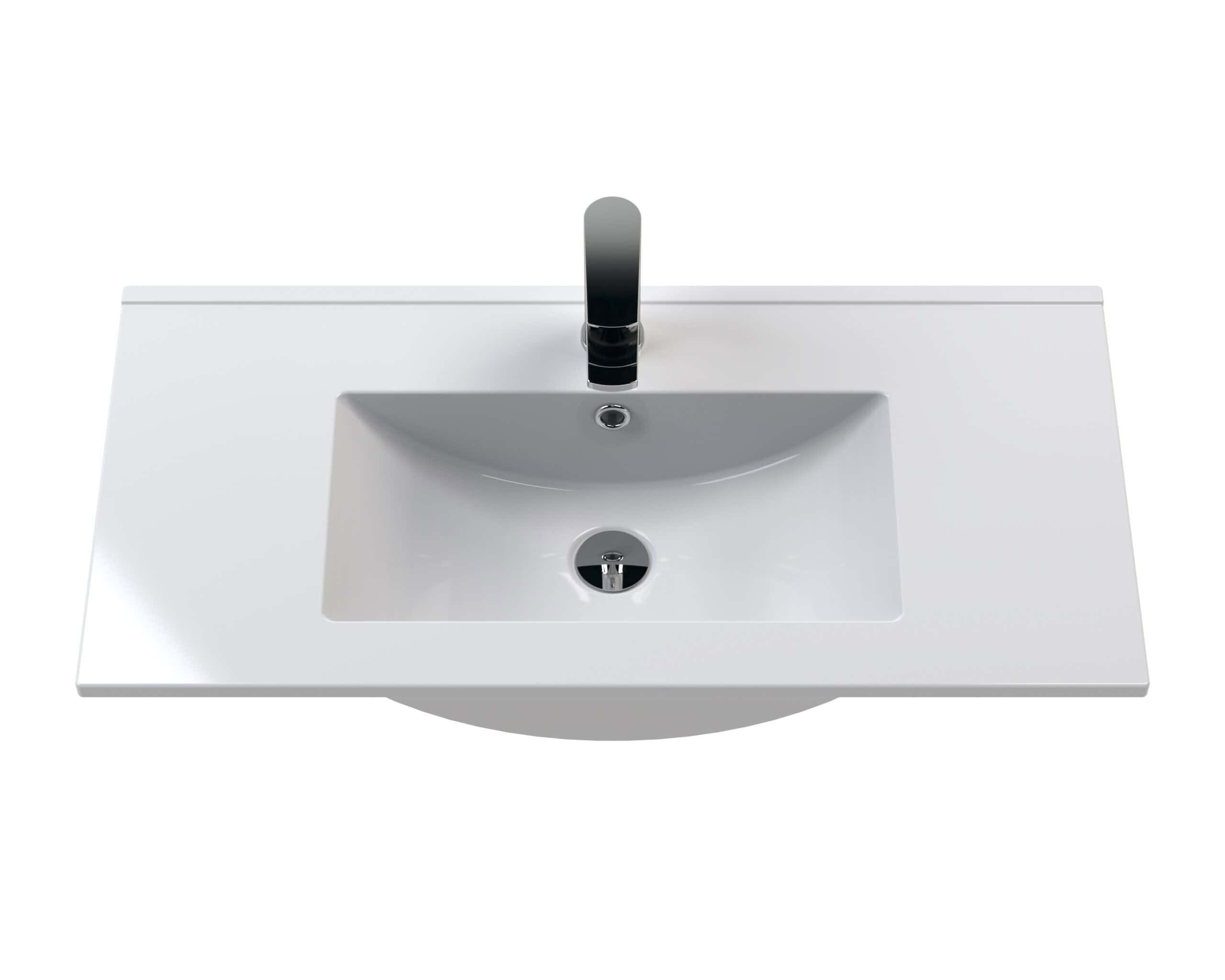 Shallow white bathroom sink with a modern chrome-finished tap, designed for stylish and practical bathroom decor.
