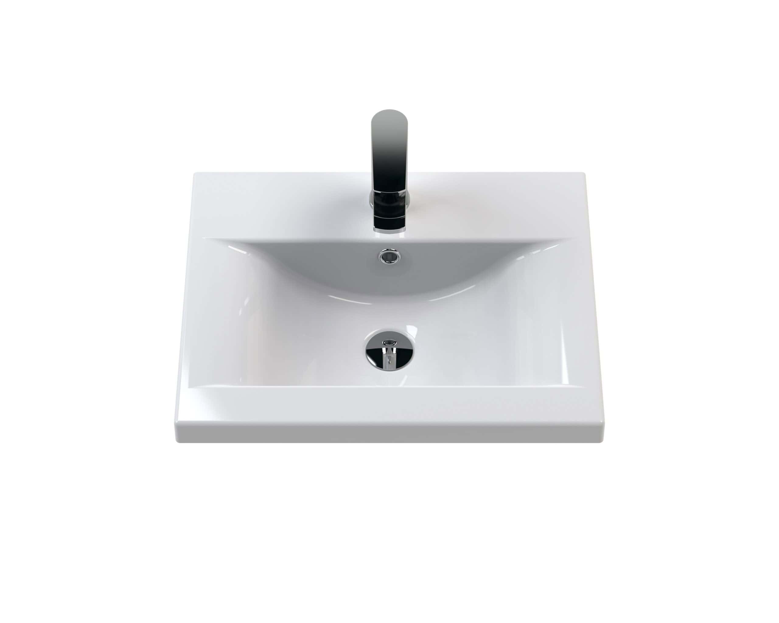 Polished white bathroom sink with modern black faucet, ideal for contemporary bathroom renovation and design.