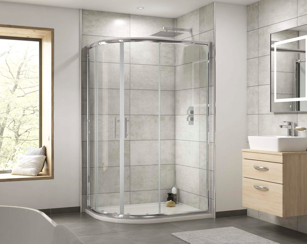 Sleek glass shower enclosure in modern bathroom with neutral grey tiles, wooden vanity with white sink, large mirror, and natural light from window, demonstrating contemporary bathroom design.