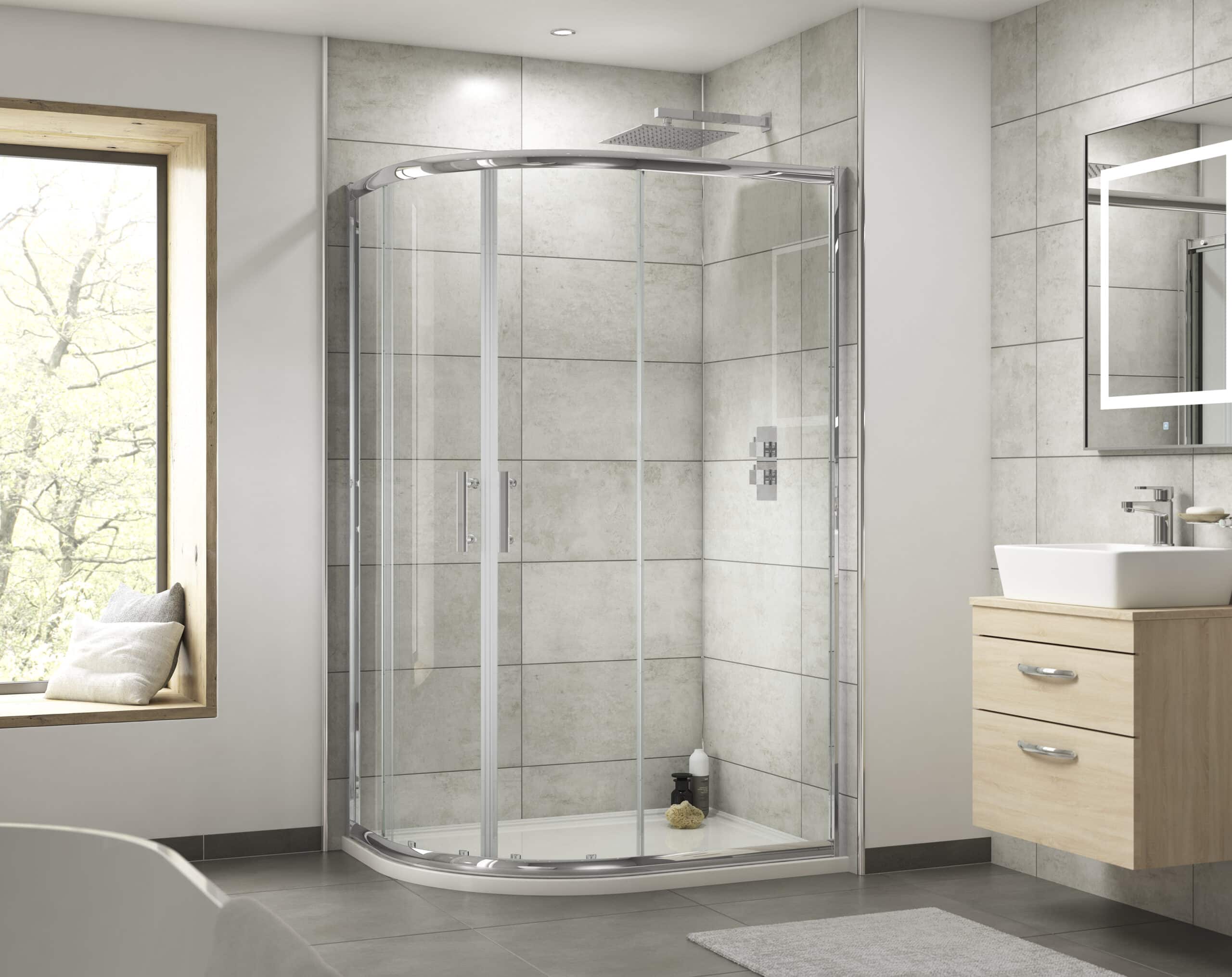 Sleek glass shower enclosure in modern bathroom with neutral grey tiles, wooden vanity with white sink, large mirror, and natural light from window, demonstrating contemporary bathroom design.