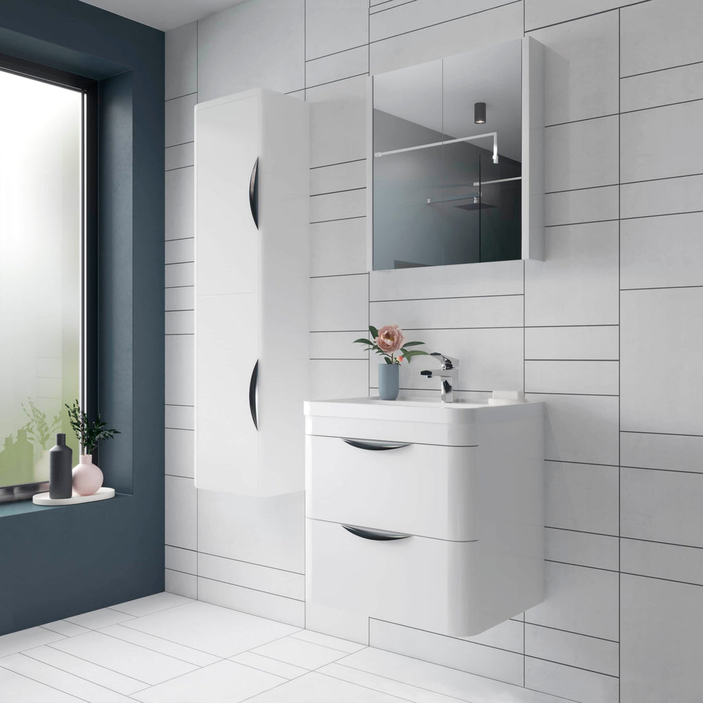 Modern white bathroom vanity with sleek cabinets and a matching wall-mounted mirror cabinet, set against a tiled wall with a dark blue accent and stylish decorative items.