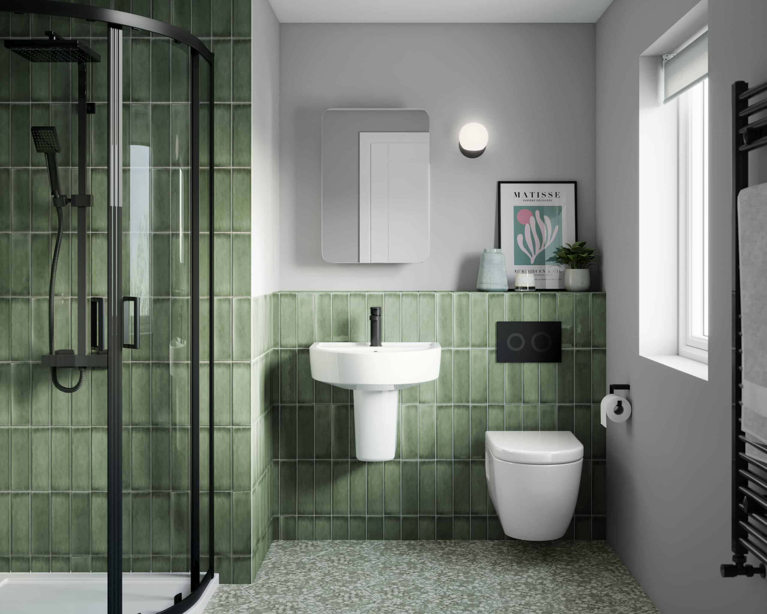 Modern bathroom with green tiled shower area, white sink, and toilet, featuring contemporary decor and natural light, perfect for stylish bathroom renovations.