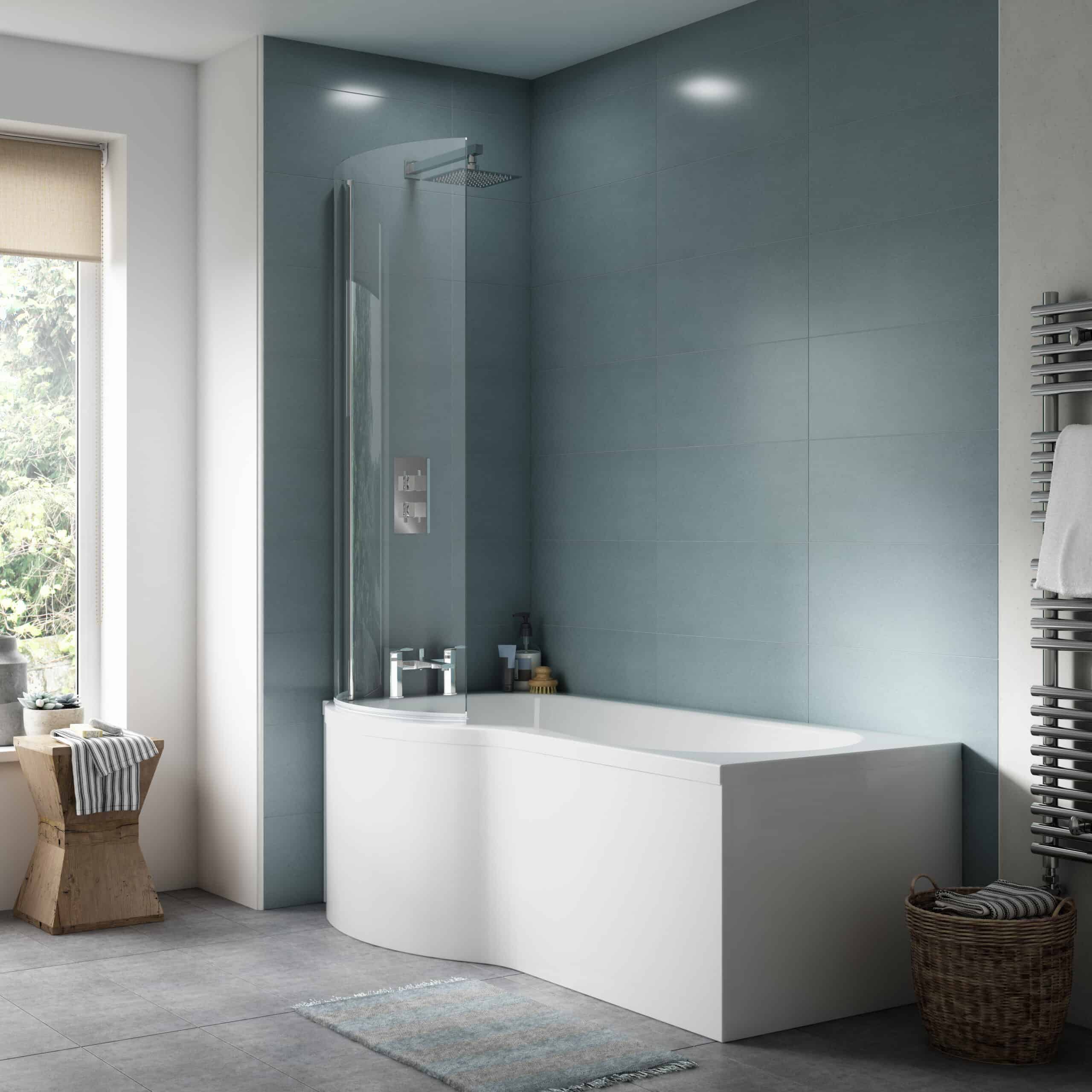 Contemporary white bathtub with glass shower screen in modern bathroom featuring blue tiled walls and chrome fixtures, ideal for relaxation and bathing comfort.