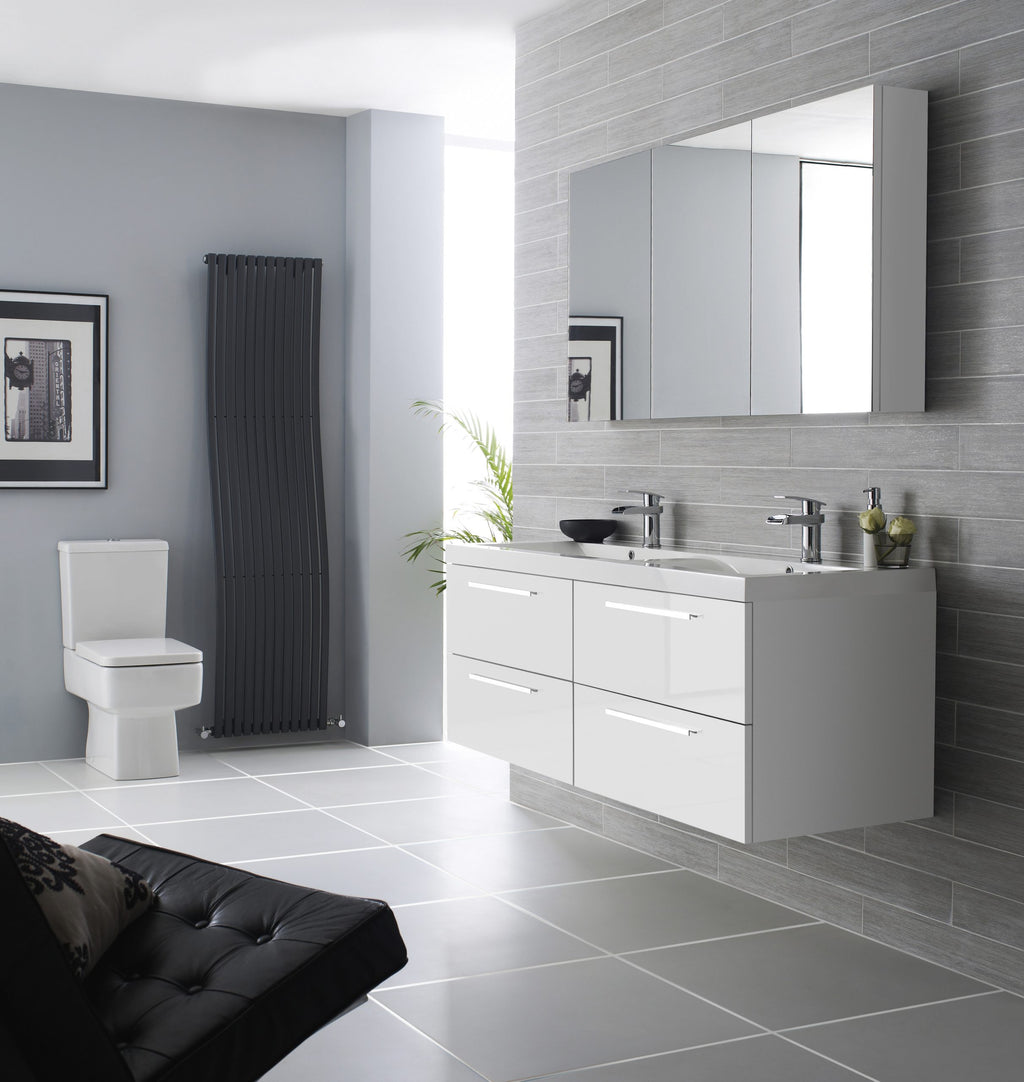 Modern white bathroom vanity with double sinks and mirrored cabinet, grey textured wall tiles, contemporary black radiator, and a sleek toilet in a minimalist bathroom design.