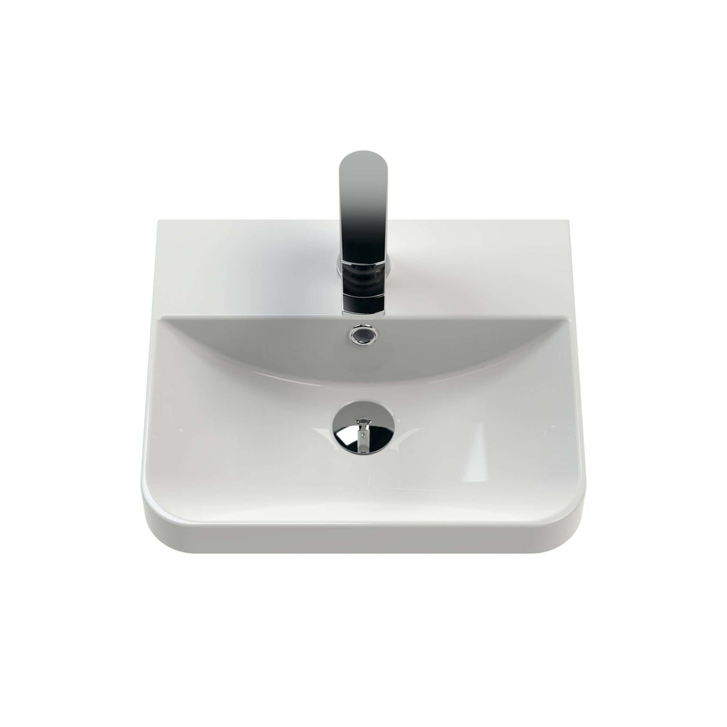 Sleek white bathroom wash basin with modern chrome-finished tap, ideal for contemporary bathroom designs and perfect for small spaces or vanity units.