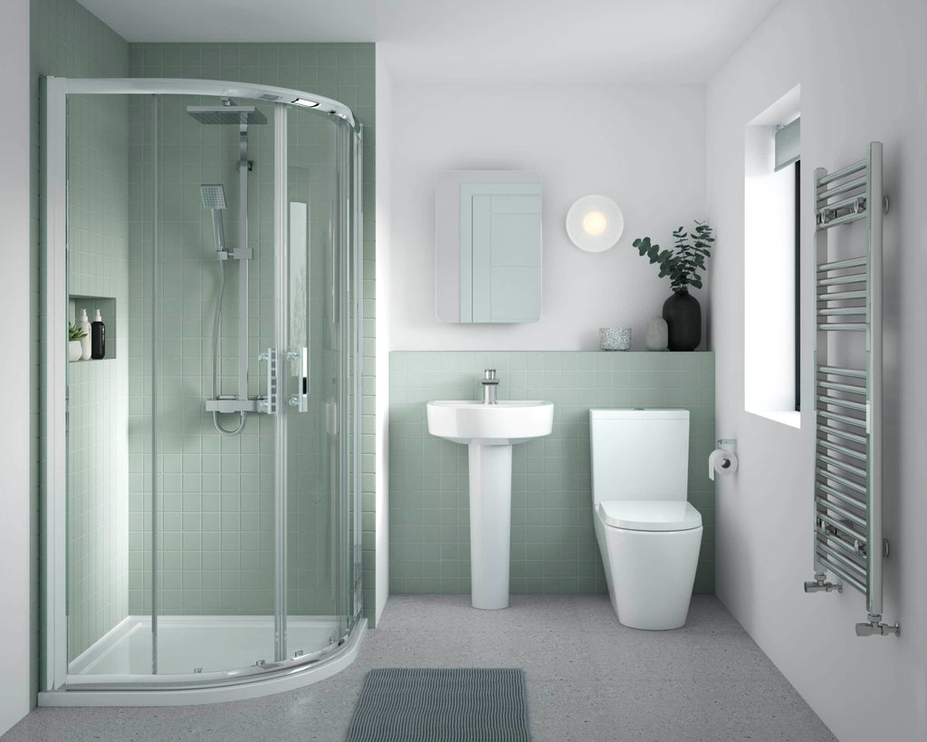 Modern green-tiled shower bathroom with a corner shower enclosure, white toilet, and sink, complemented by eco-friendly decor, creating a sleek, stylish, and functional Bubly Bathrooms space.