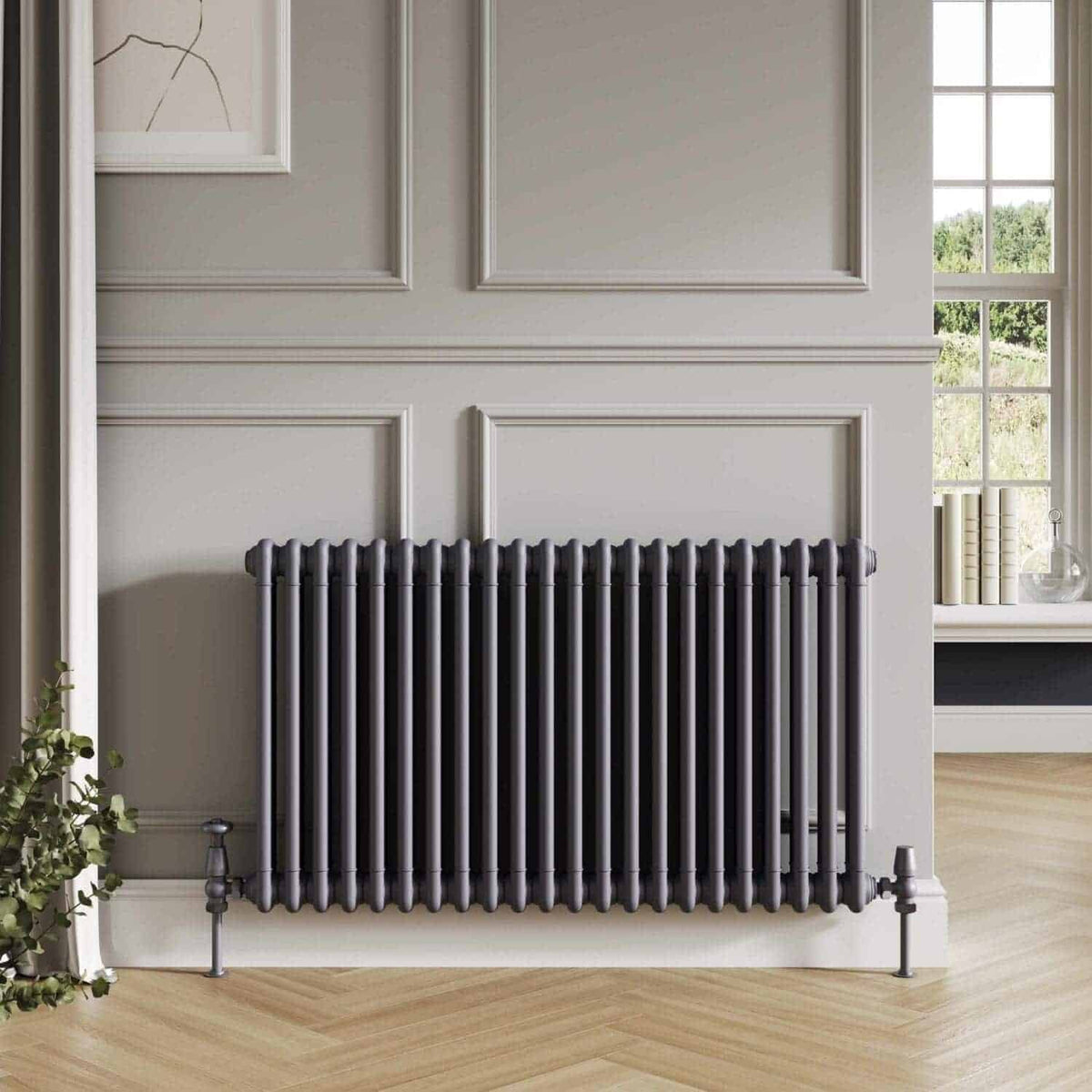 Radiator in elegant grey finish against classic wall paneling in a modern bathroom setting.