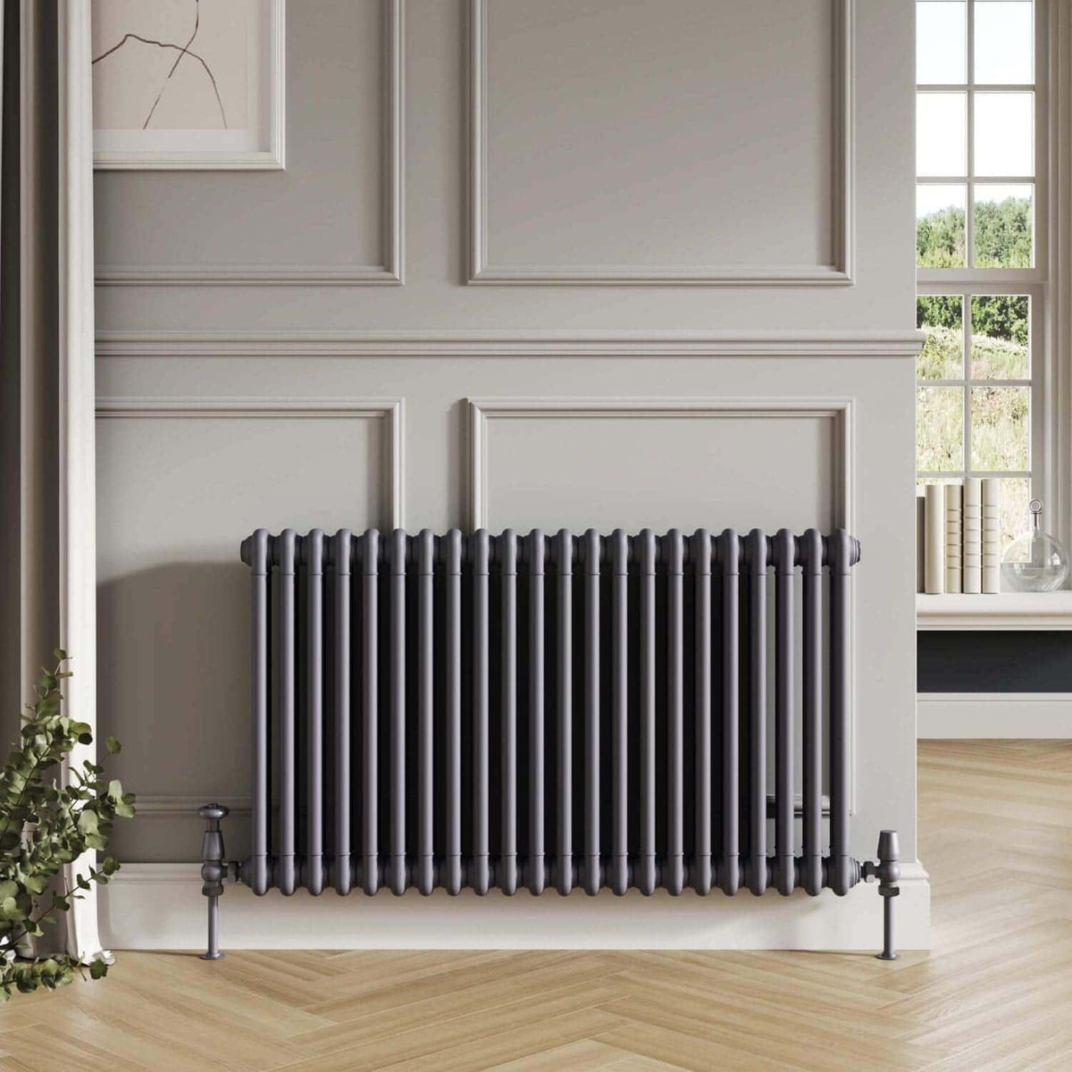 Vintage-style black radiator in a modern bathroom with elegant wall paneling and large window, creating a sophisticated and cosy atmosphere.